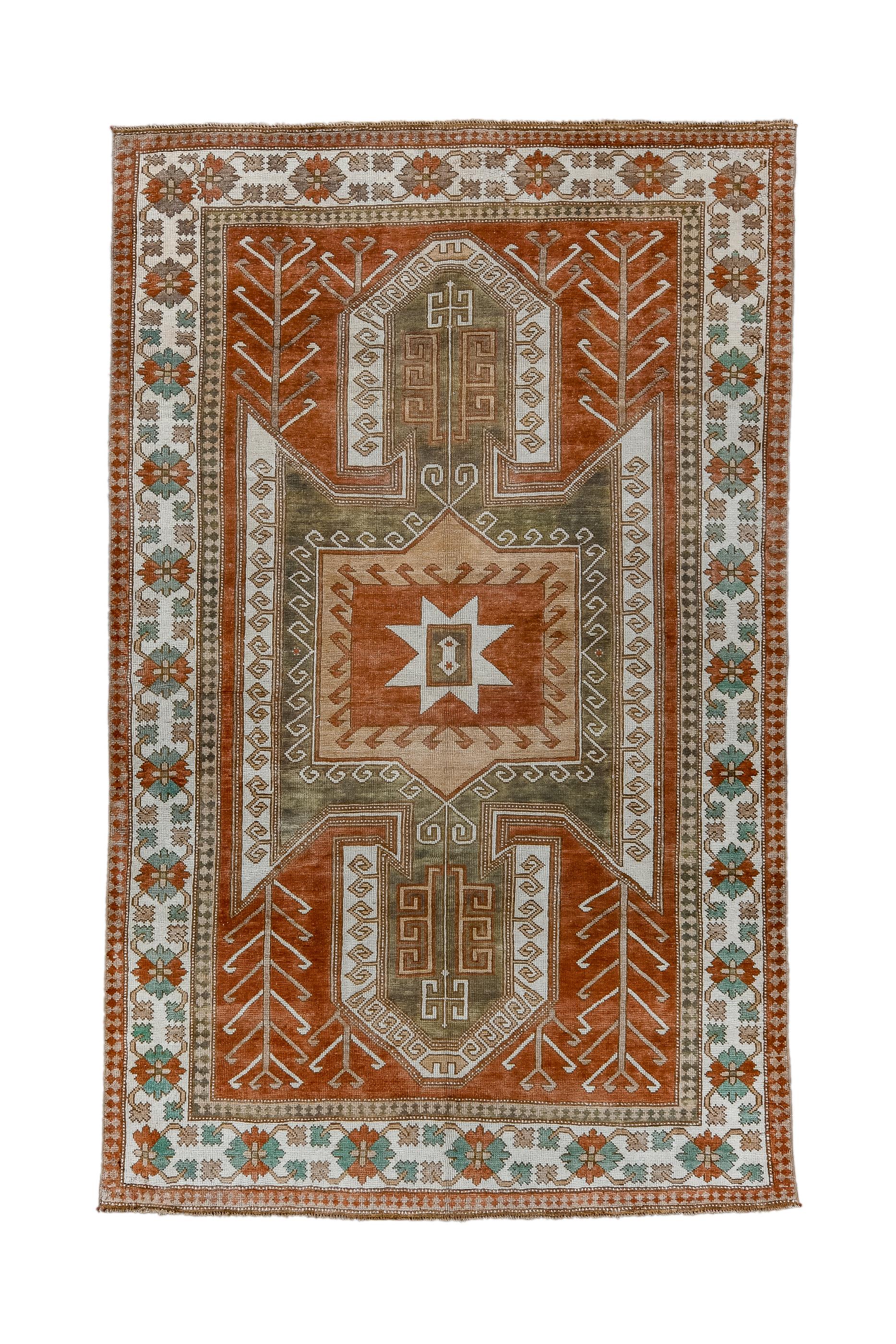 Kars, along with Tiflis and Erivan marks the limits of the Caucasian Kazak weaving area and it is no surprise to find Kars rugs in Caucasian Sewan Kazak patterns. Here the red field shows a bold, winged medallion, with nested and hooked panels