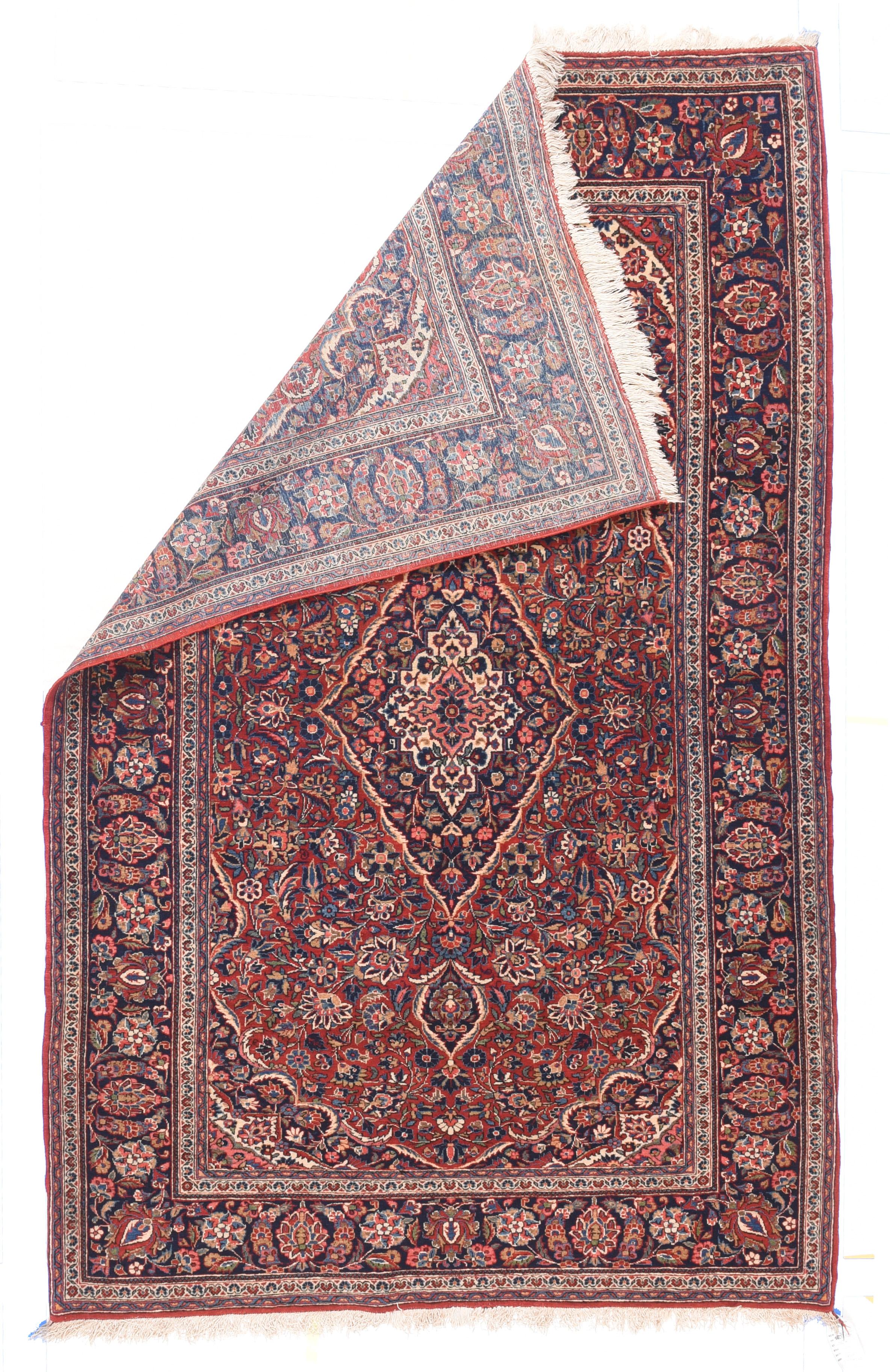 Antique Persian Kashan Rug 4'4'' x 7'2''. This is an absolutely iconic Interwar Period Kashan scatter from central Persia with a red/navy/cream palette expressed in a tall, lozenge medallion, swirling arabesques with petal palmettes, and a navy