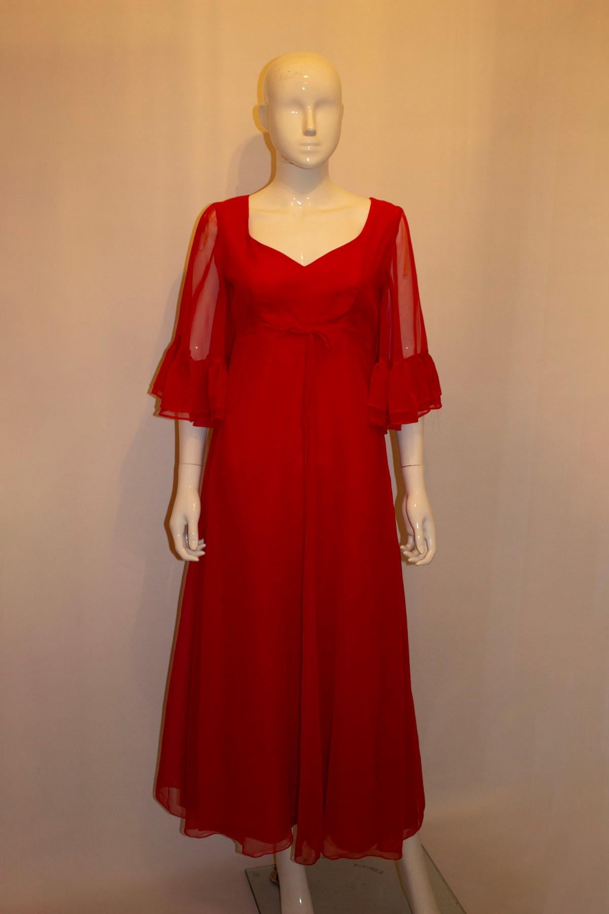  A headturning lady in red, vintage gown by Kati, Laura Phillips. The dress has a v neckline, short angel sleaves and a central back zip. It is fully lined. 
Old size 12. Measurements Bust 35'', length 53''