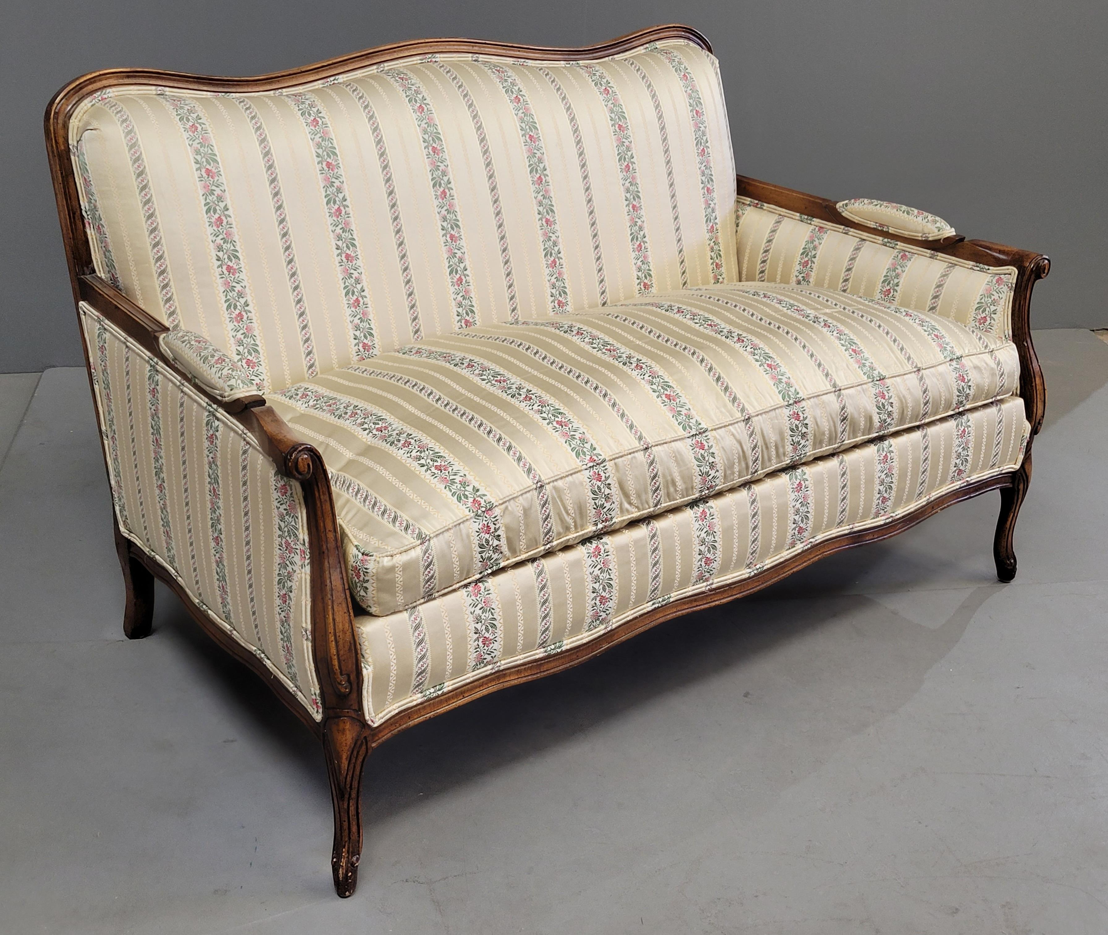 An absolutely stunning vintage (late 1970s or early 1980s) Kay Lyn Inc. walnut stained wood frame French style settee loveseat with gorgeous sateen stripe upholstery in shades of cream, beige, pink and green. Note the floral upholstered armrest