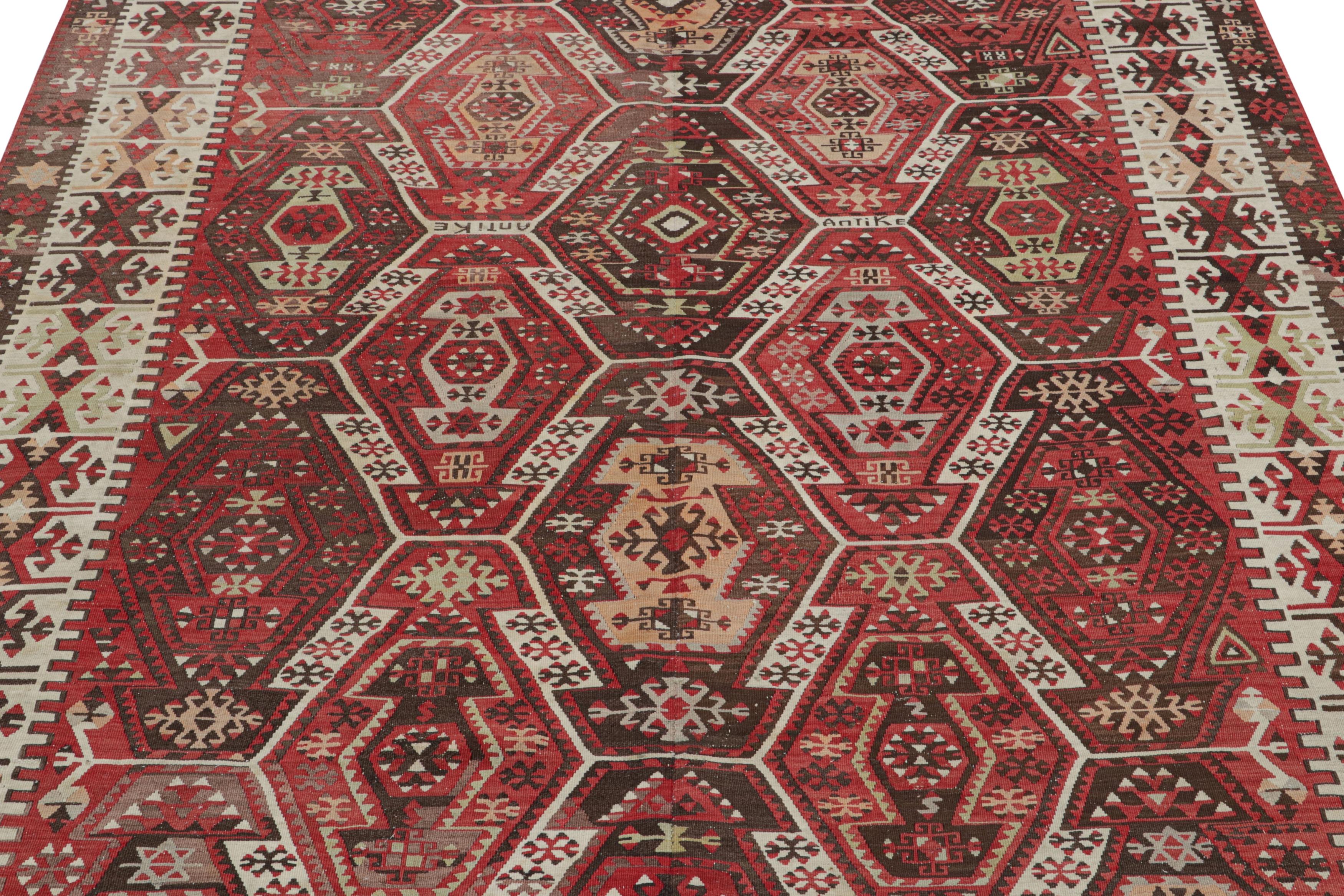 Originating from Turkey between 1930-1950, this vintage Kayseri wool Kilim rug enjoys a classical sense of symmetry in a beautiful large-scale graph complementing the marriage of forgiving and rich colorways. Flat-woven in high-quality wool with