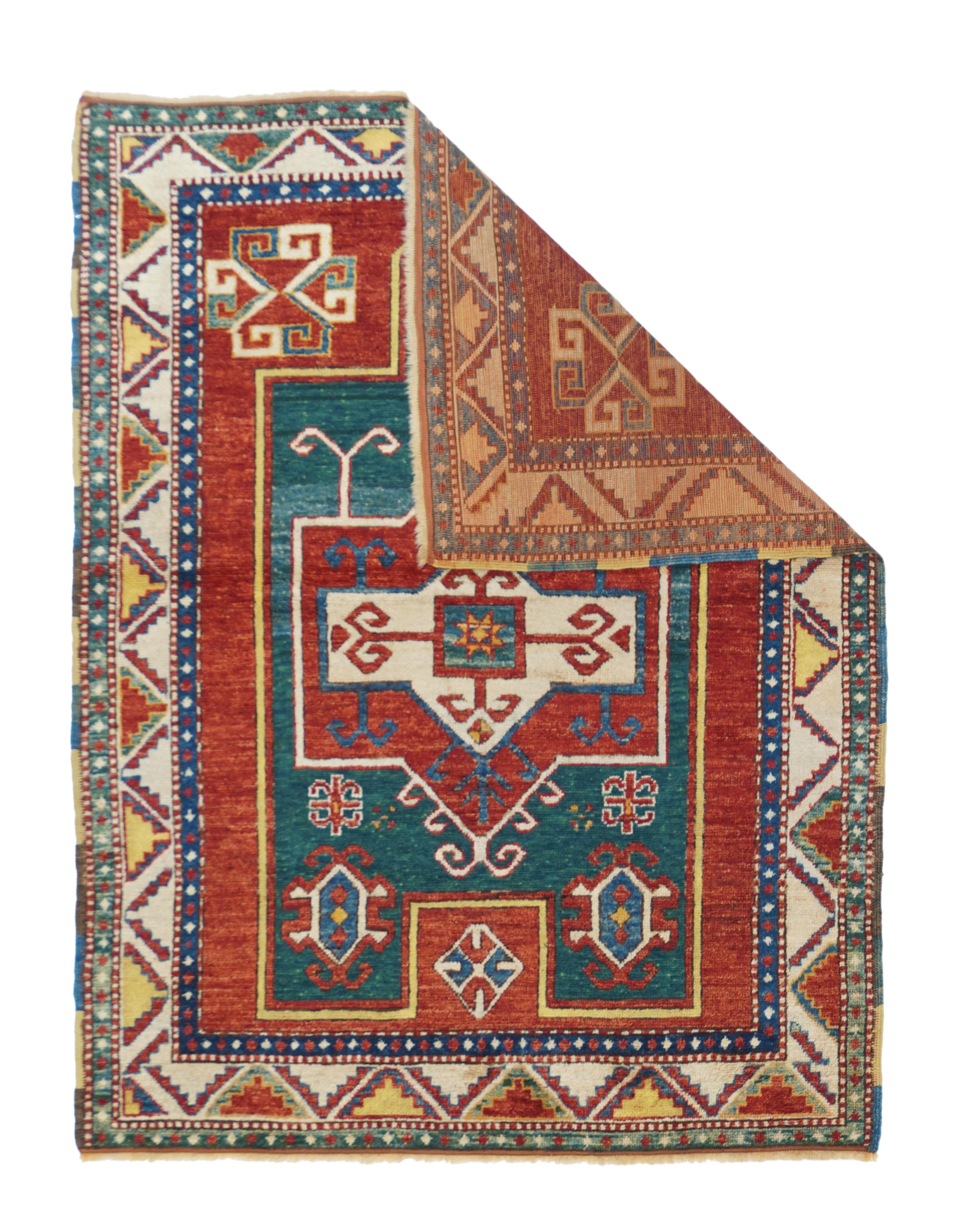 This is a very classic Fachralo type of southwest Caucasian Kazak prayer rug with a relatively narrow natural dye palette including: madder red for the field; abrashed denim blue for the floating niche area; yellow and green for accents; and dark