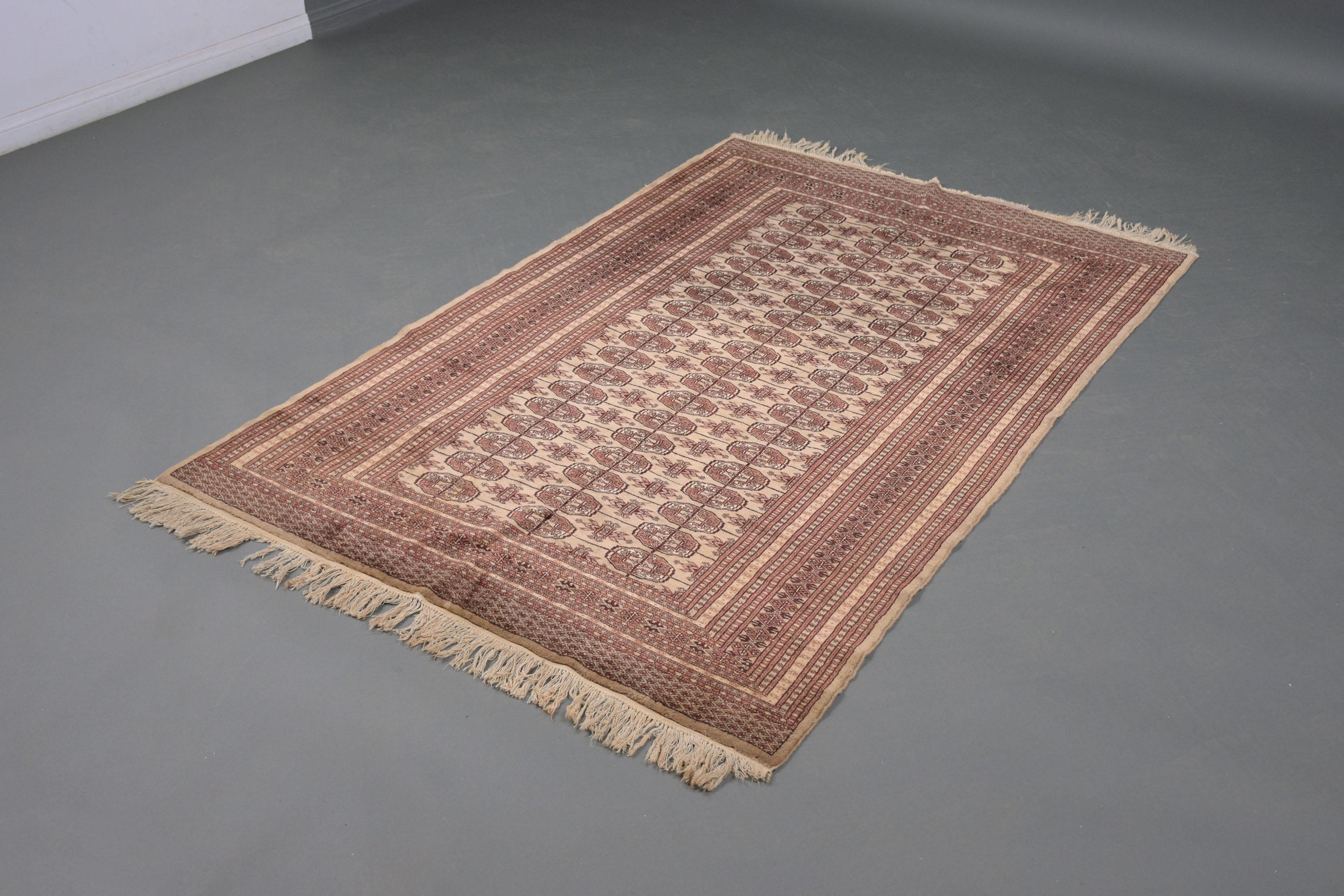An extraordinary vintage throw rug hand-crafted out of wool this piece features a traditional design and is in a good condition has normal wear from use and age and some loss to the fringe.