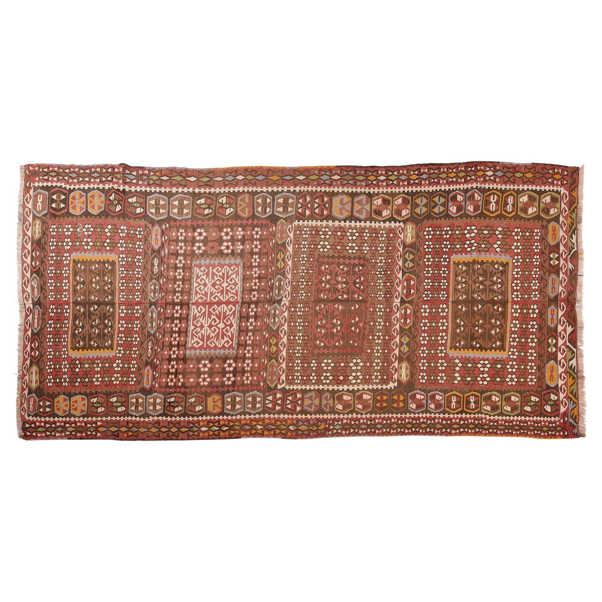 nr. 935 - Large old Turkish kilim, composed of two partes sewn in the center: typical nomadic workmanship.
The dark background color for wool is used by nomads to rest their eyes from the blinding sun.
Light brick colors with grey, white, and small