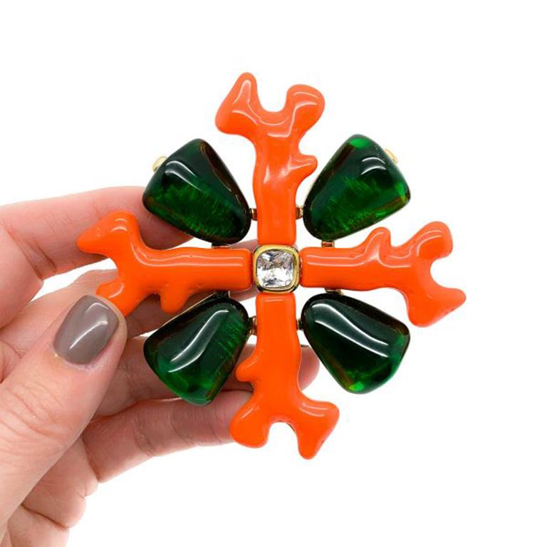 A supersized Vintage KJL Maltese Cross Brooch. Featuring resin coral branches and resin tumbled emeralds centering on a fancy cut crystal stone. Crafted from resin, glass and gold plate. 8cm. Very good vintage condition. Signed. A stunning and