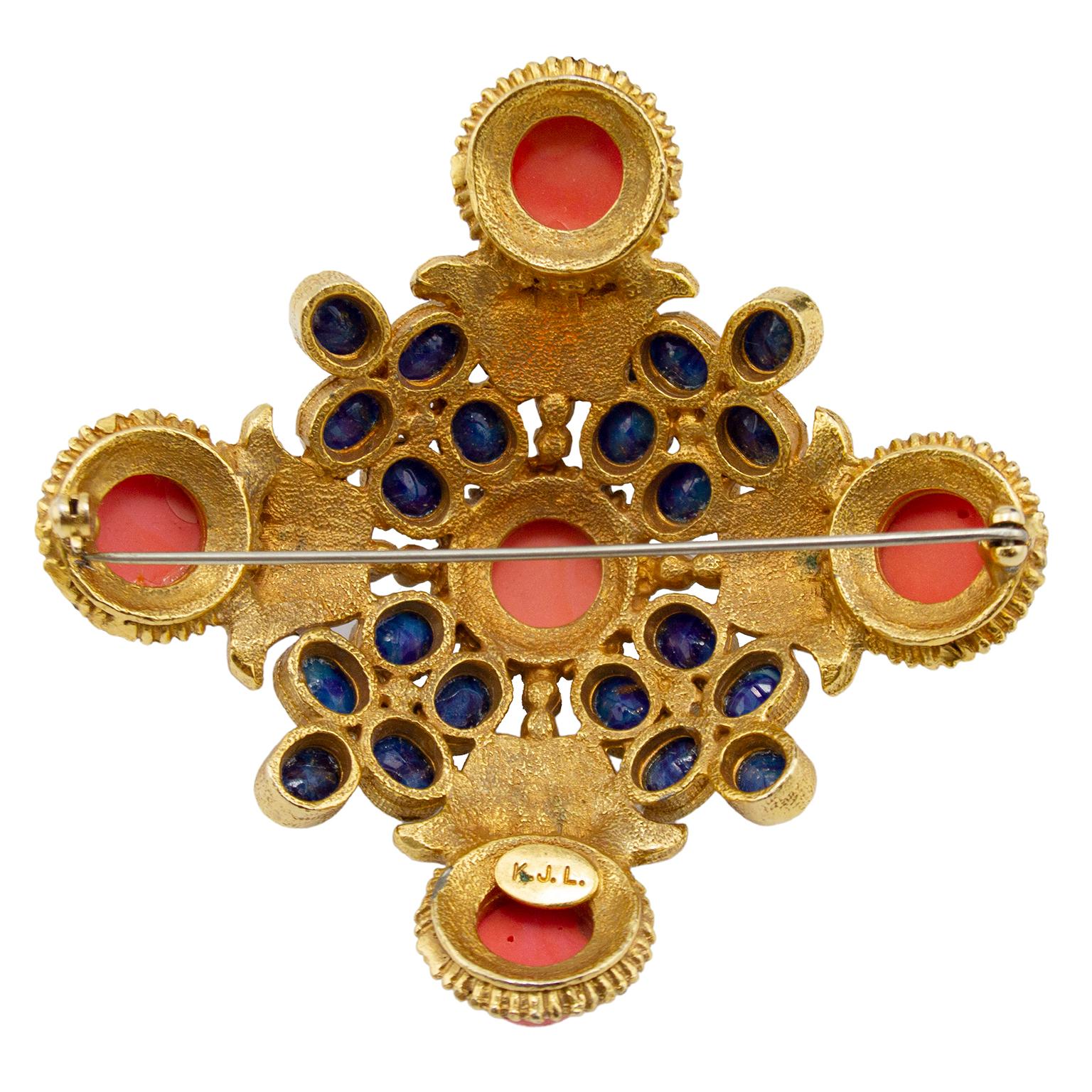 Possibly 1960's  or 1980's version of large Maltese cross style pin featuring faux coral and faux lapis cabochons, encrusted in rhinestones set in antiqued gold plated metal. Pin closure. Signature on the back K.J.L. with no copyright symbol leads