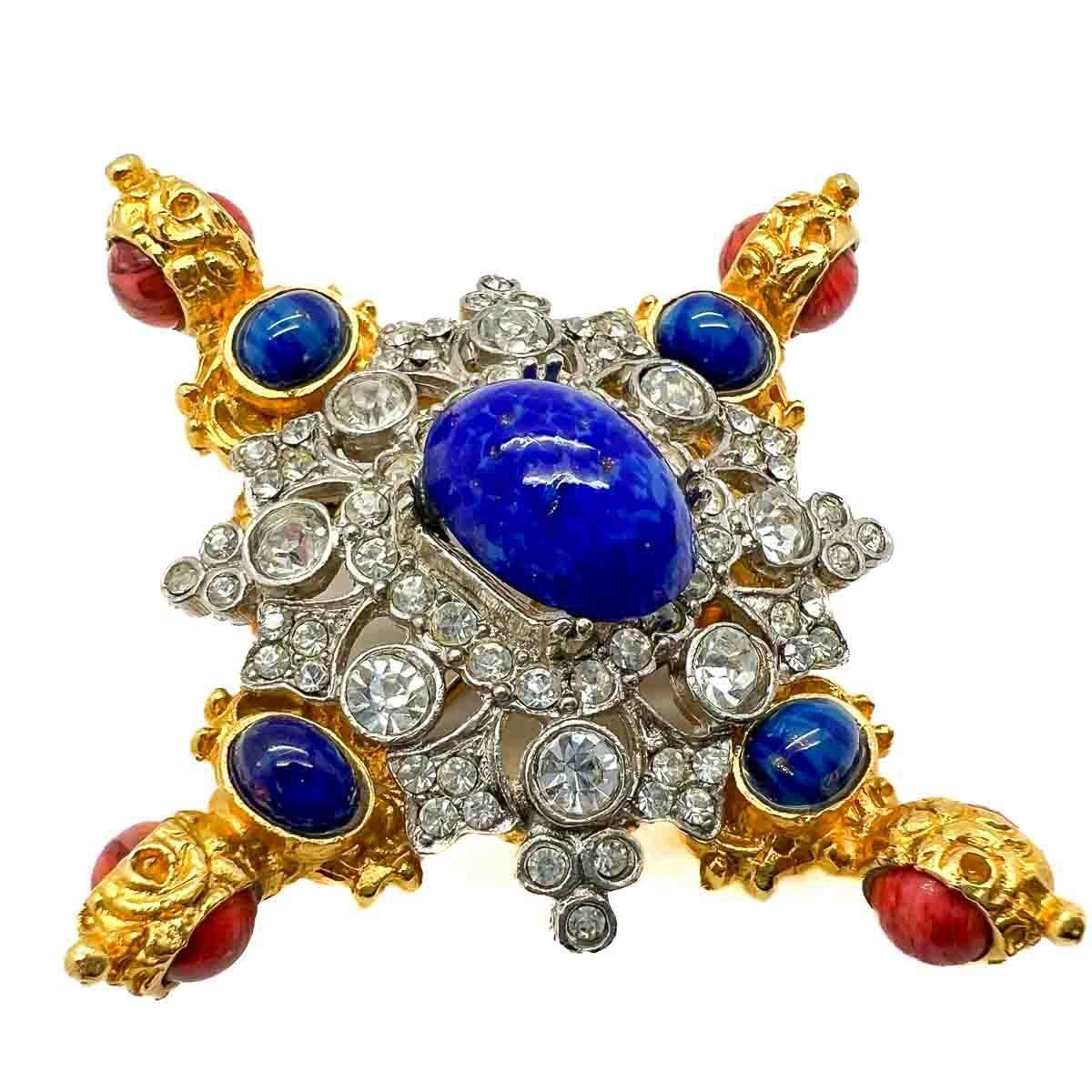 A spectacular Vintage Kenneth Jay Lane Jewelled Cruciform Brooch. A lavish cruciform inspired design is richly embellished with lapis and coral glass cabochons and finished with pave chaton crystals. Rich, opulent and eternally stylish, this work of