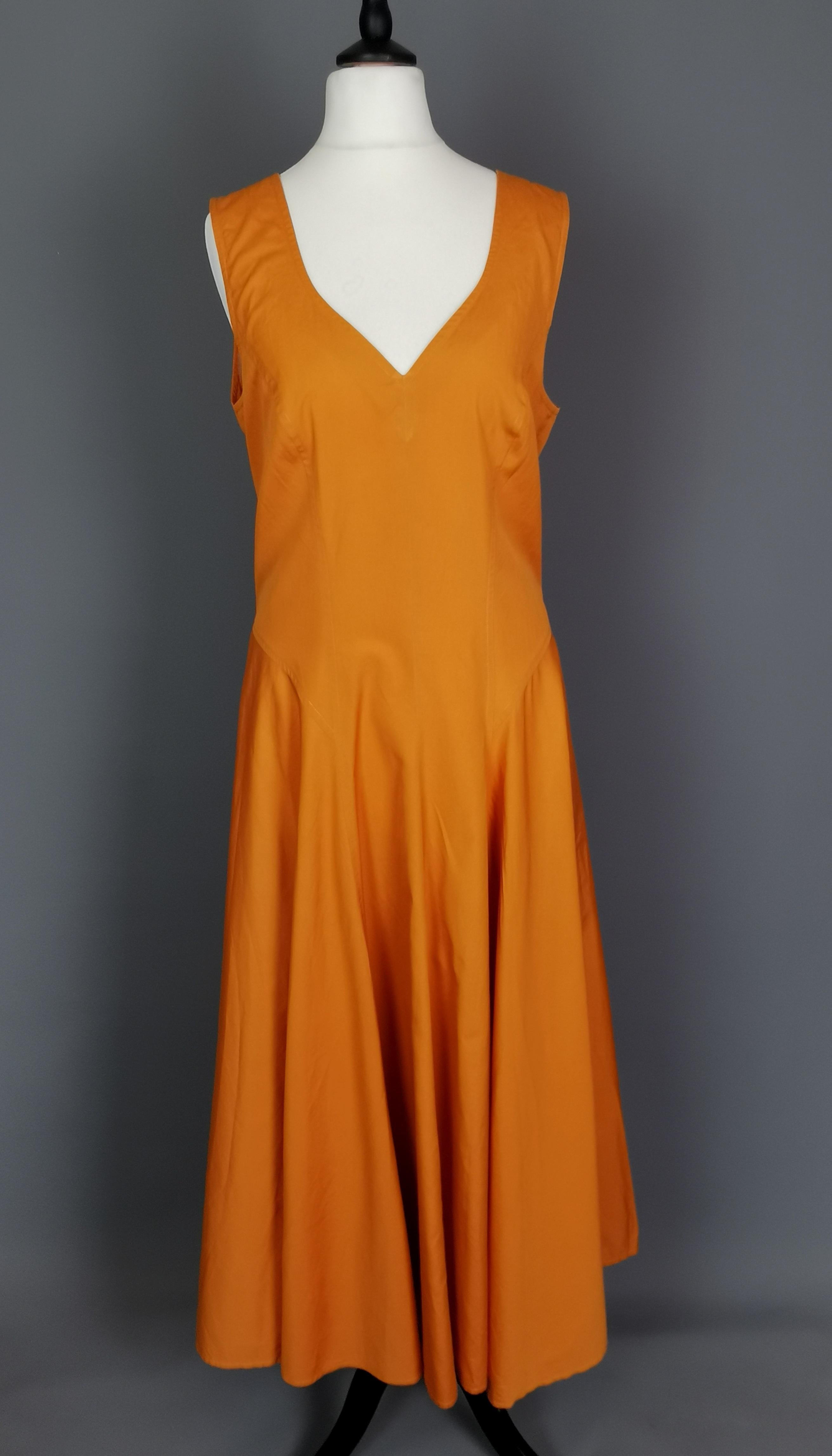 A gorgeous vintage c1980s Kenzo burnt orange sun dress.

A lovely floaty summer dress, sleeveless with wide straps and a c neckline.

It is slightly nipped in at the waist with full swishy skirts and a full bust.

The perfect comfy yet stylish