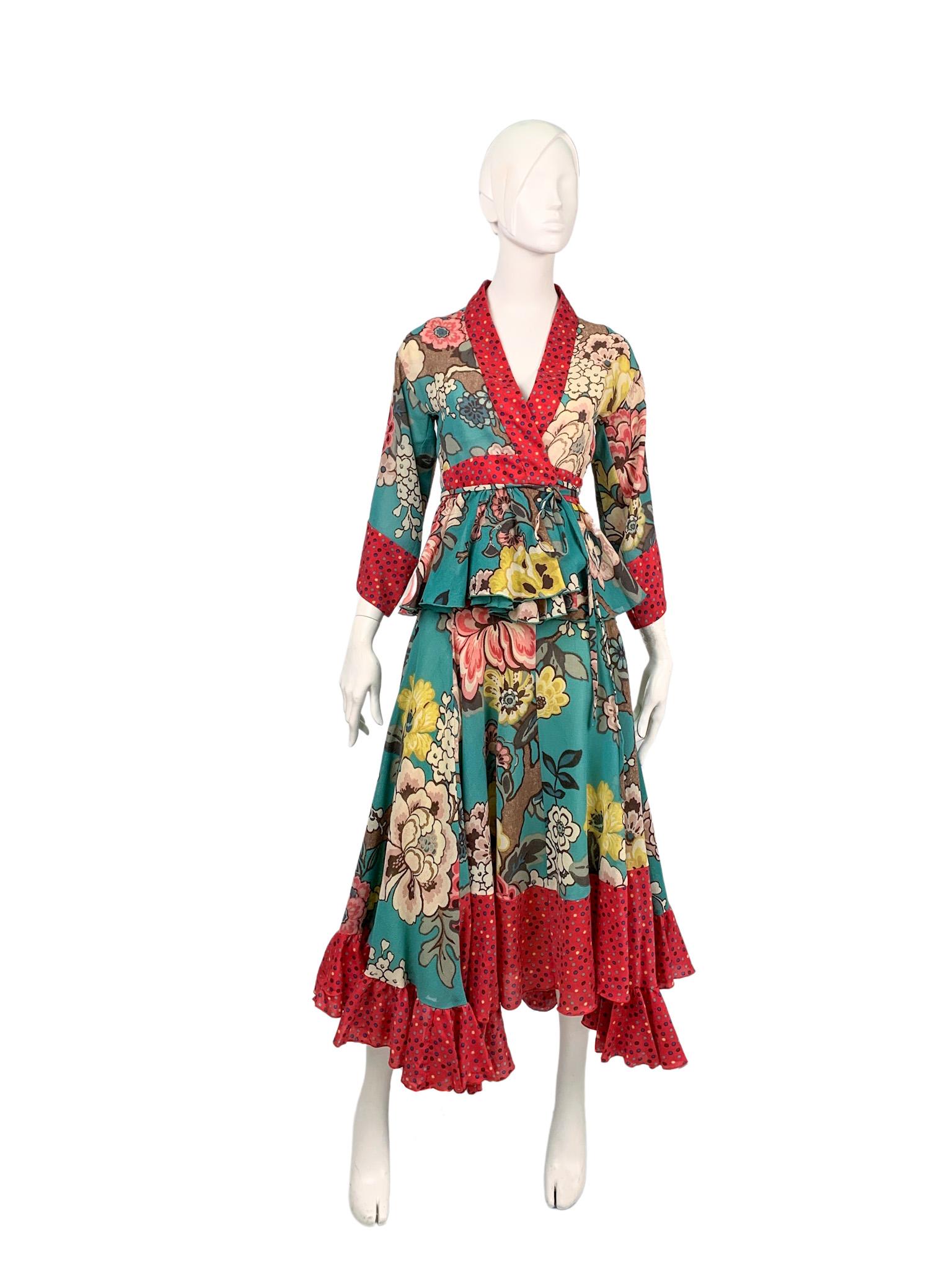 Kenzo 2-piece ensemble with an exceptional patchwork design that masterfully combines contrasting floral and polka dot prints. Includes an asymmetric ruffled skirt and a wrap kimono-style jacket/top.

100% wool; trims 70% wool 30% silk; skirt lining