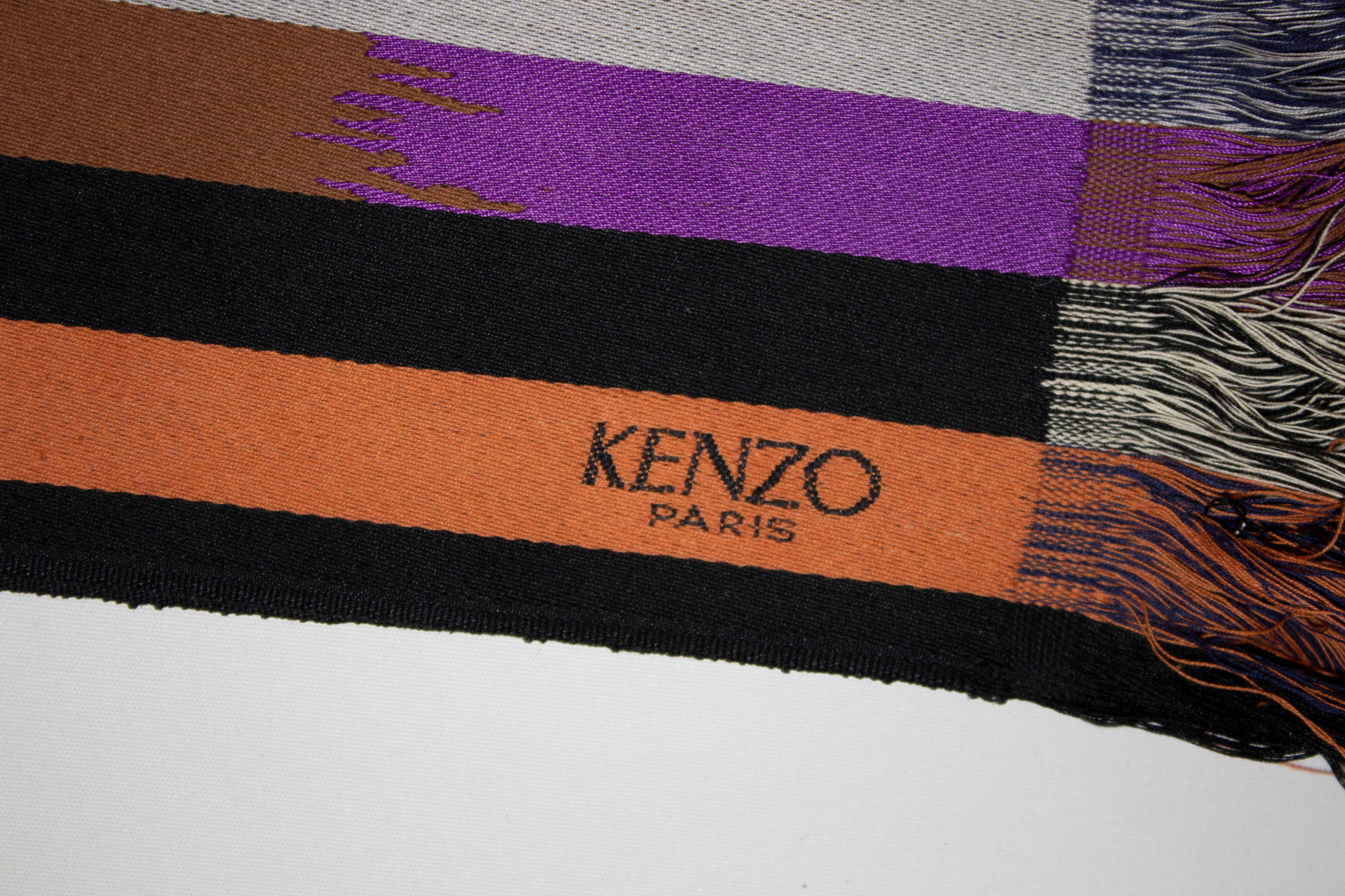 A stylish vintage belt by Kenzo Paris. The obi style belt is in shades of brown and orange with fringe detail. Measurements: Height 4 1/2'' length 76'' without fringing.