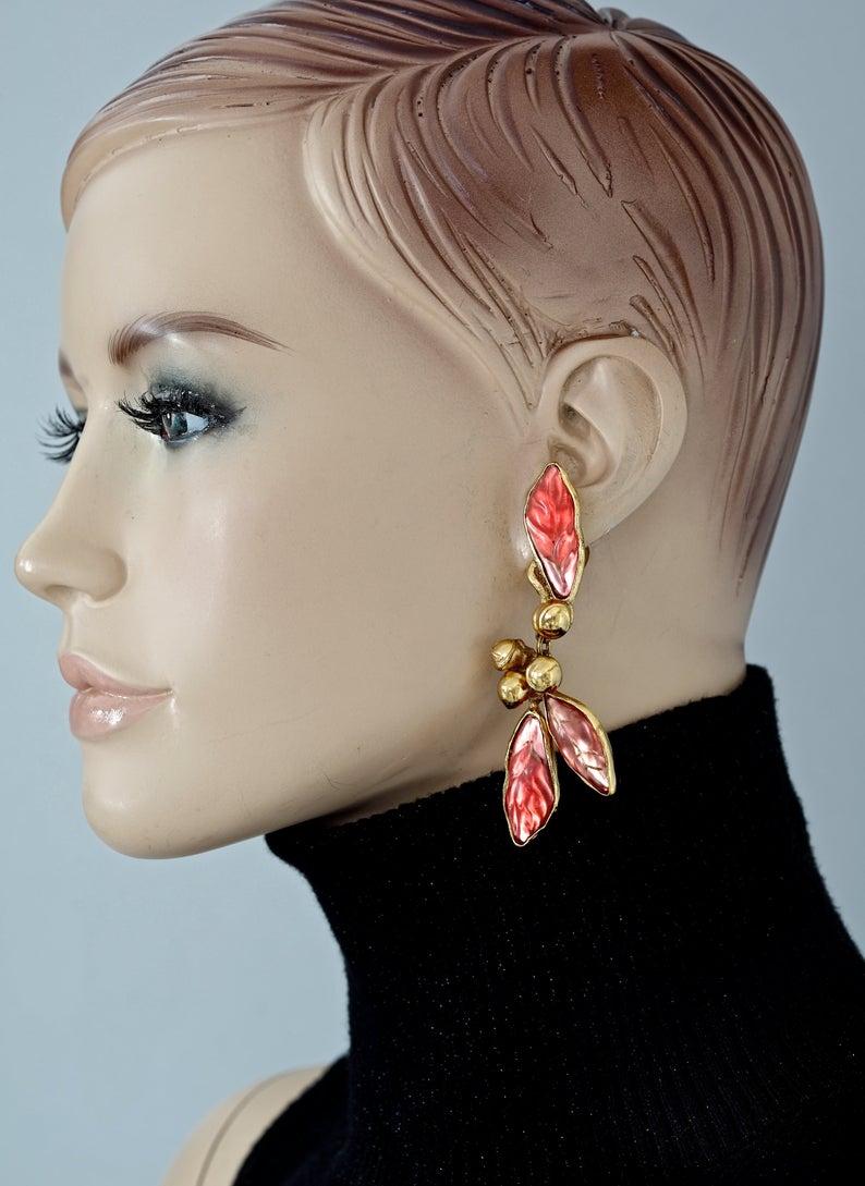 Vintage KENZO PARIS Pearl Lucite Leaves Dangling Earrings

Measurements:
Height: 3.15 inches (8 cm)
Width: 1.22 inches (3.1 cm)
Weight per Earring: 26 grams

Features:
- 100% Authentic KENZO PARIS.
- Red orange lucite leaves dangling earrings.
-