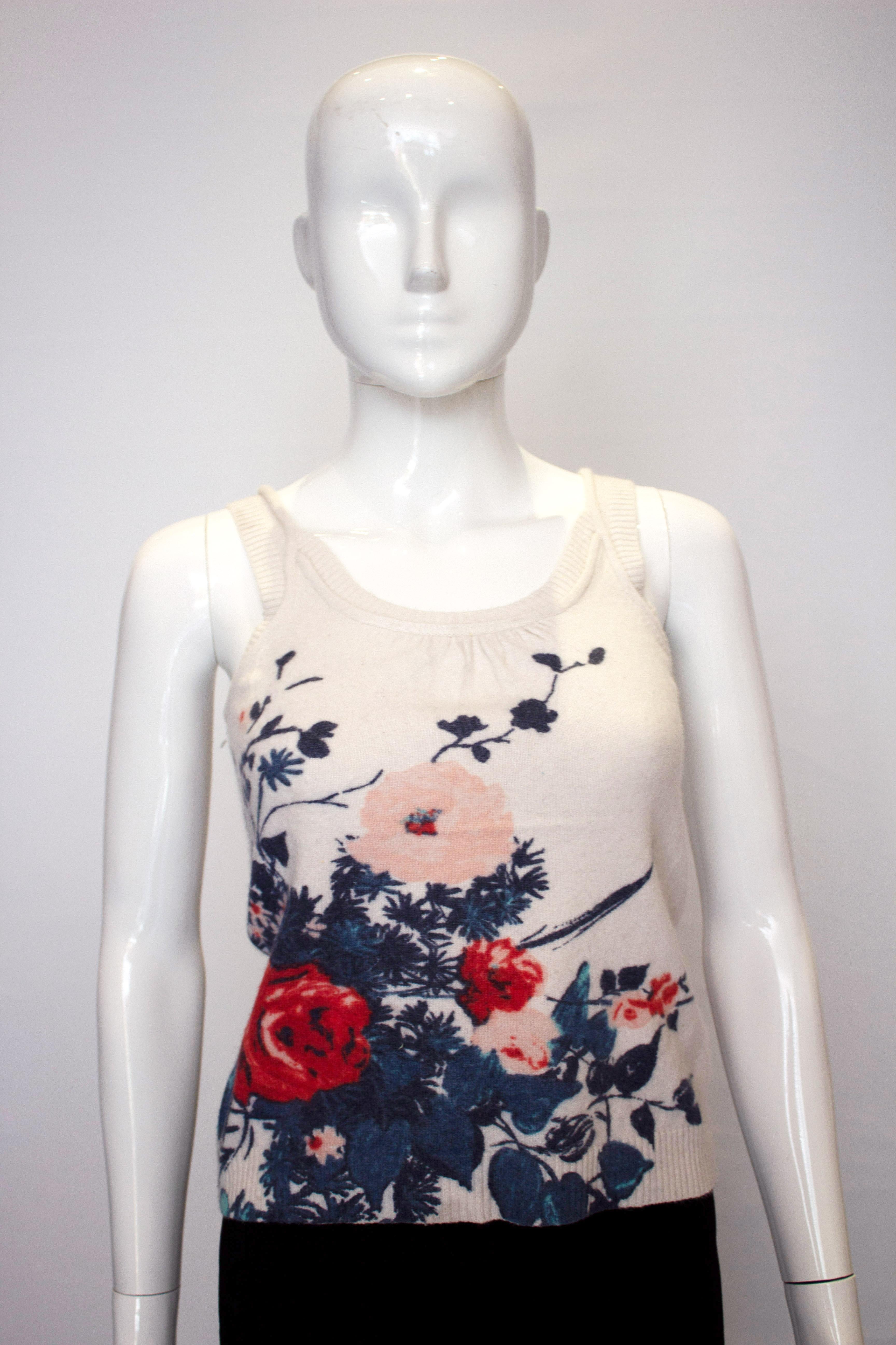 A fun tank top for Spring/Summer by Kenzo.  The top has a round neckline with ribbing on the shoulders and a floral design on the front and back.