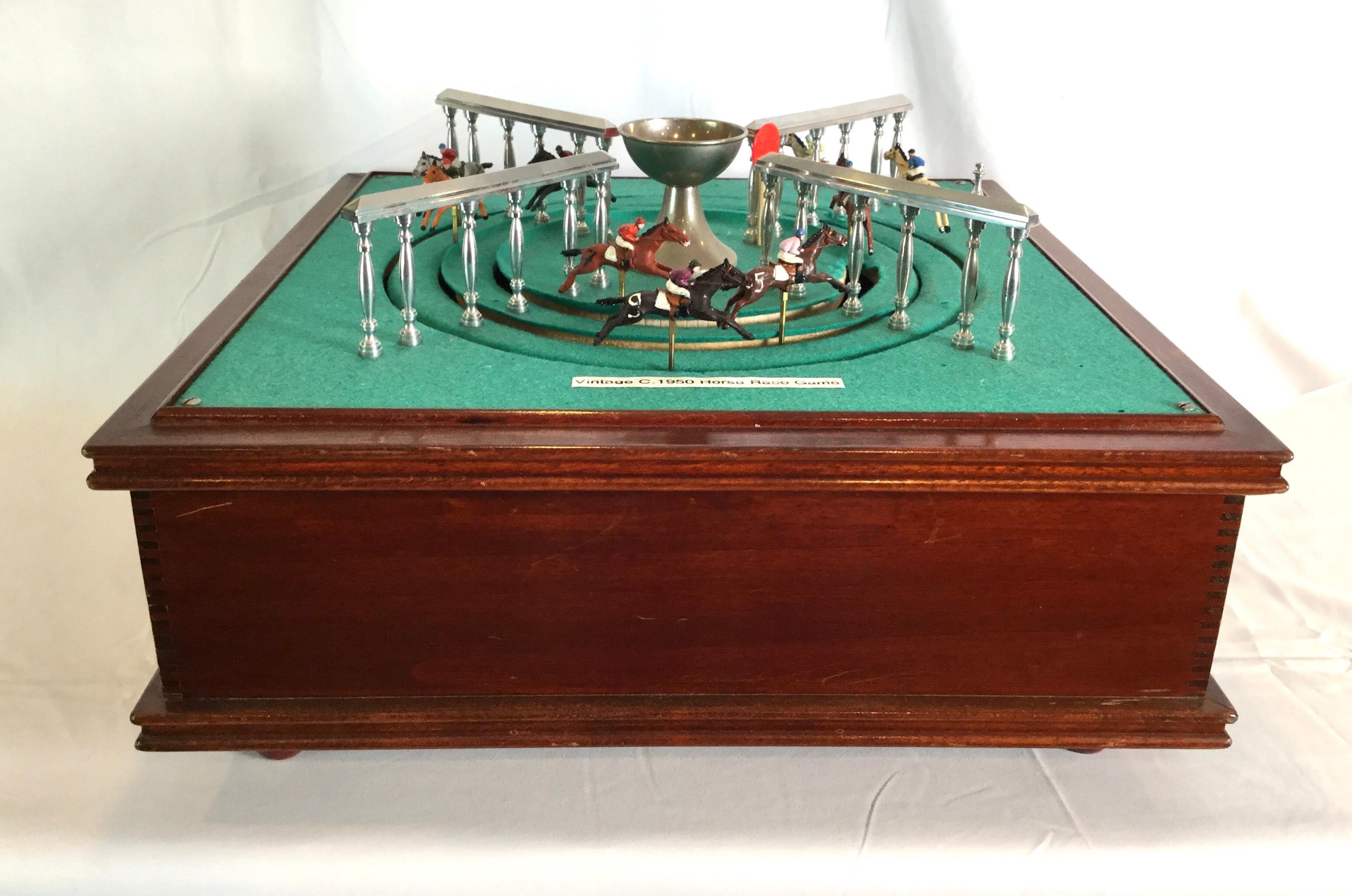 Vintage key wind horse race game from the 1950s. Good working condition. Green felt on top has wear from age and use.