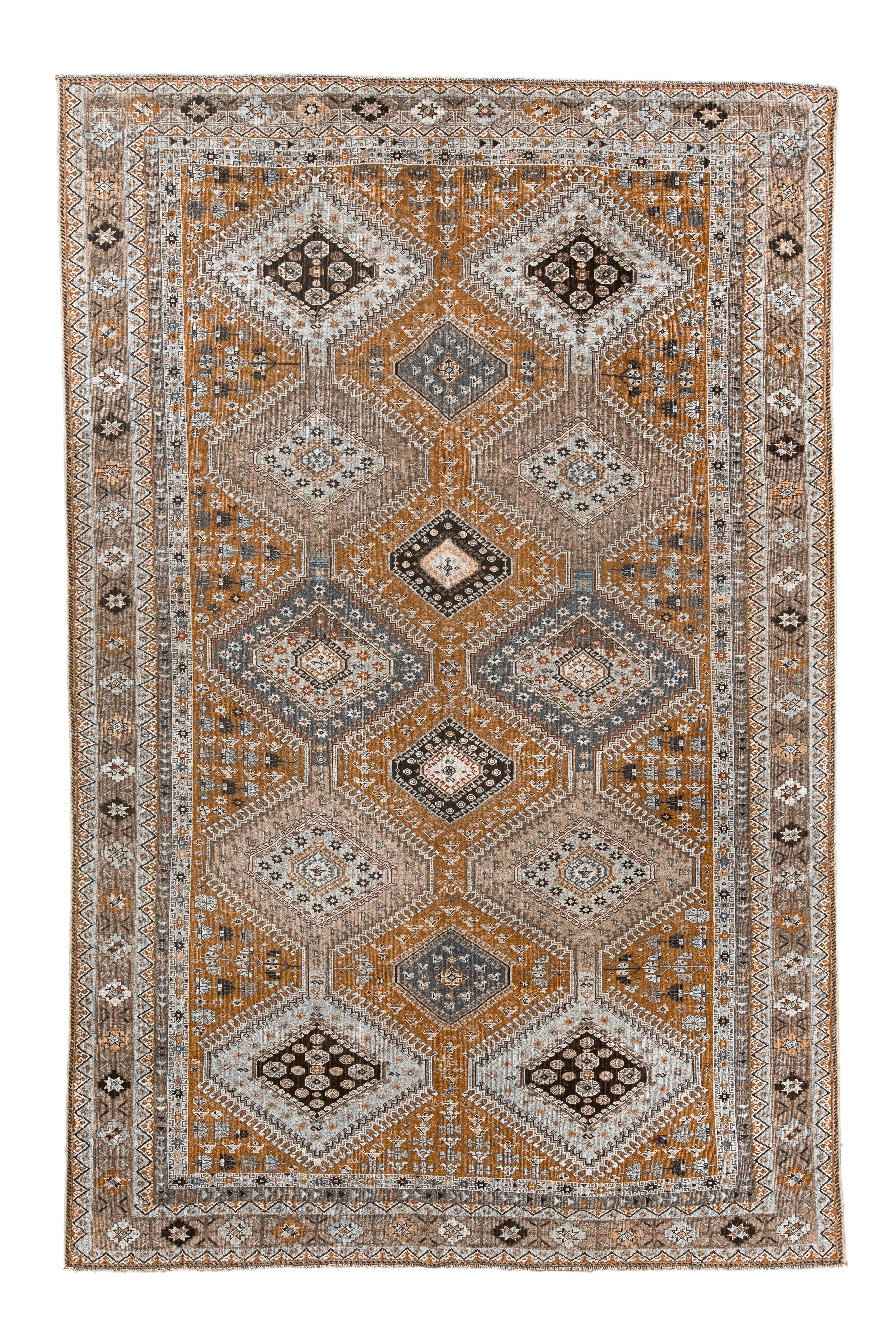 The rusty red field is mostly covered by two poles composed of lavishly hooked and nested flattened hexagons in slate, near black, putty and ecru. Smaller, similar hexagons up the centre and a lavish fill of Aladdin’s lamps throughout.  Stars and