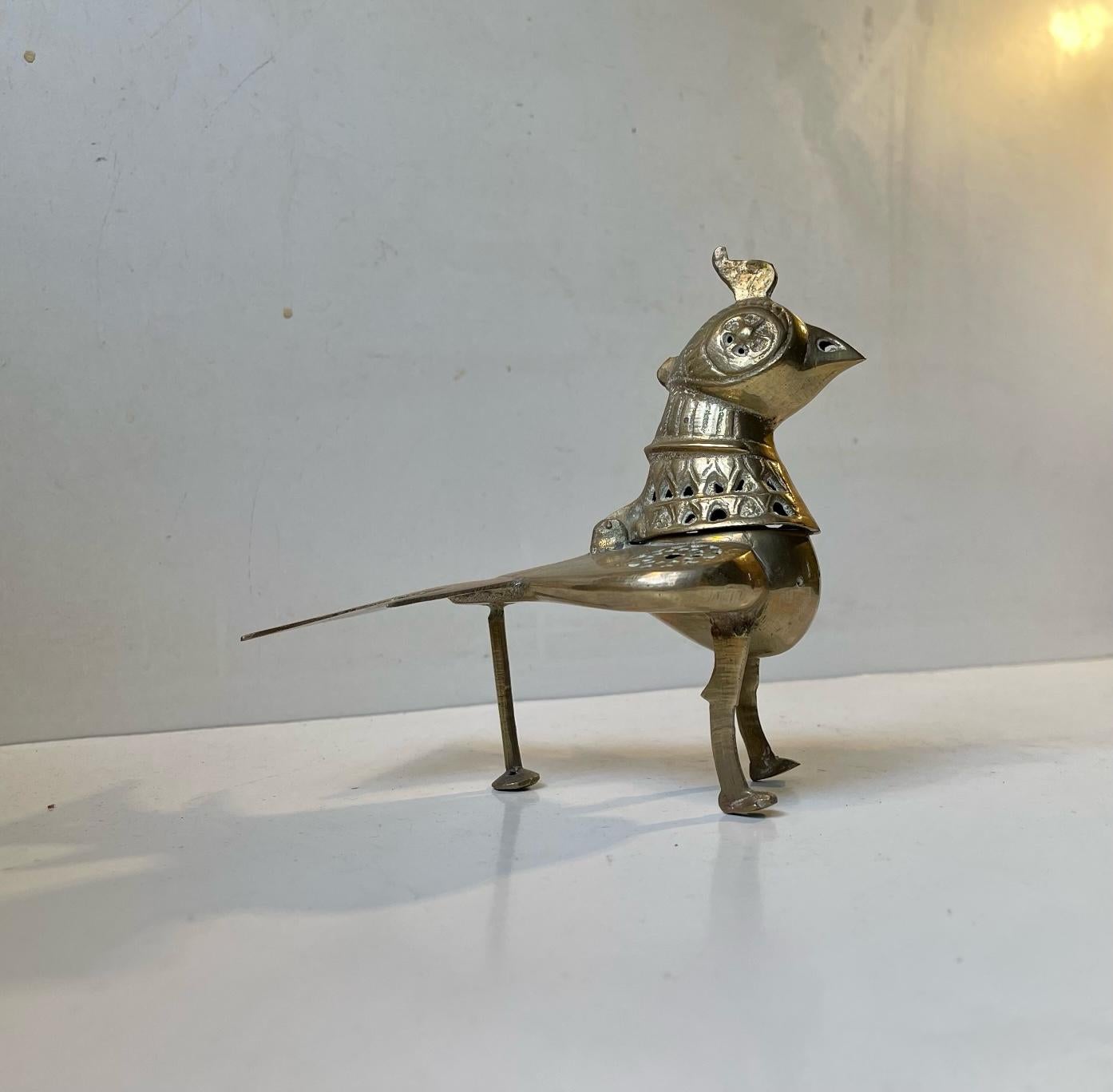 A 1970s interpretation of a 17th century Bird/chicken incense burner from the region of Khorasan in Afganistan. It stands peculiar yet proud. Its made from solid brass - partially perforated allowing the incense to spread in the room. Distinct