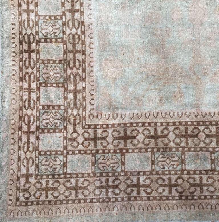 Vintage Khotan Gallery size rug, 6'5 x 13'1. An Antique Khotan with a natural abrash on the borders. An abrash is a natural change in color that occurs when different dyes are used and gives uniqueness an extra beauty to the rug. The rug has been