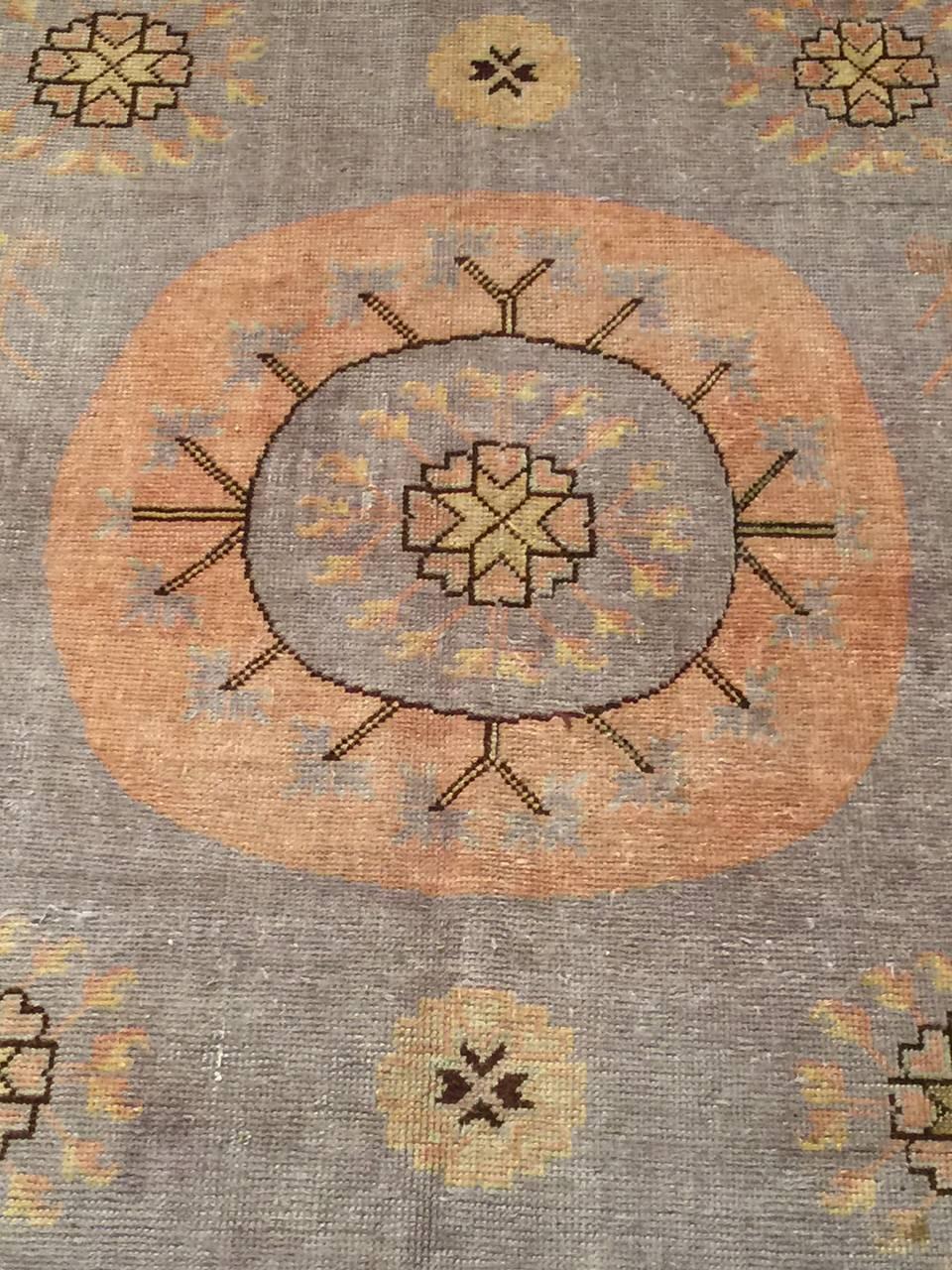 Vintage Khotan Samarkand rug, circa 1920. The decorative rugs are great accent pieces, using a great balance of geometric and floral motifs. The size and shape makes is ideal for entry ways. The condition is excellent. Colors: Lilac and peach. Size: