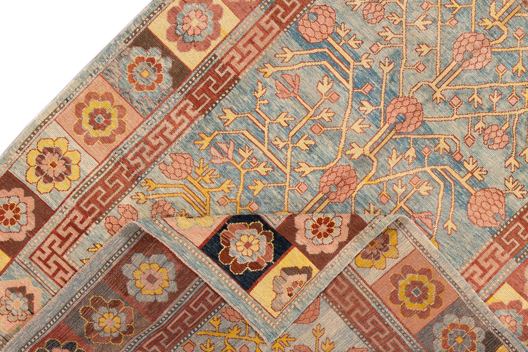 Beautiful Vintage Khotan style hand knotted wool rug with a blue field, and multi-color accents in an all-over geometric floral design.

This rug measures 6' 7