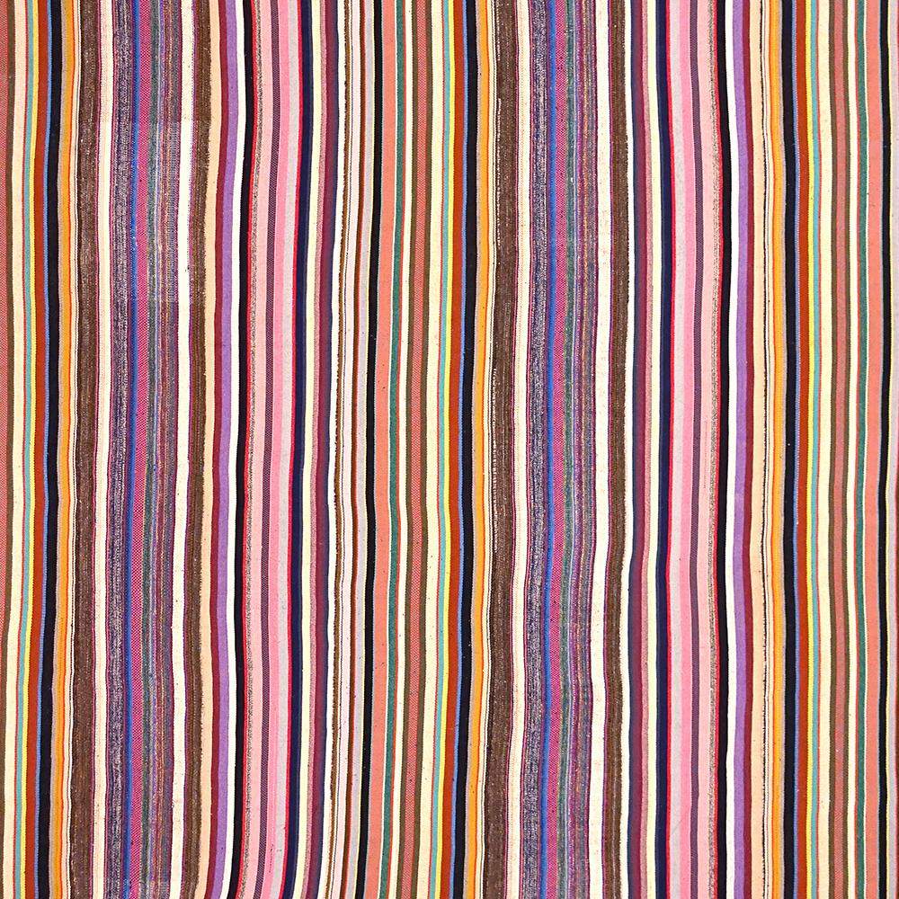Mid-End-20th Century Handwoven Anatolian Multi-Color Striped Vintage Kilim

This vintage kilim from Southwest Turkey was handwoven in the second half of the 20th century. It is lined with a cotton fabric to maintain stability and to protect the