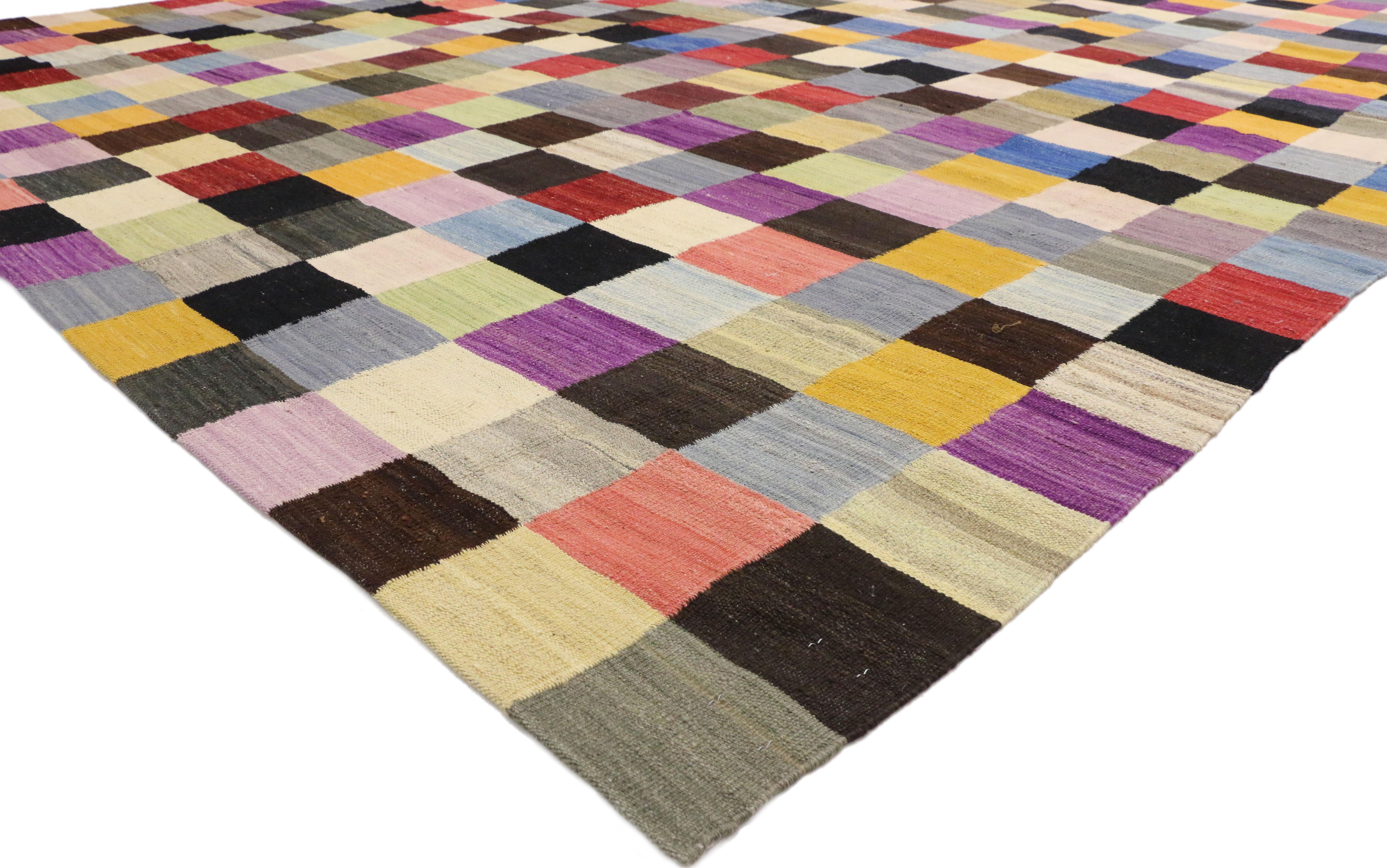 80094 Vintage Checkered Afghan Kilim Rug, 09'07 x 12'08. This handwoven wool vintage Afghan Kilim rug showcases an all-over checkered grid pattern, a motif that echoes the bold geometries and dynamic compositions of Cubist art. Composed of small