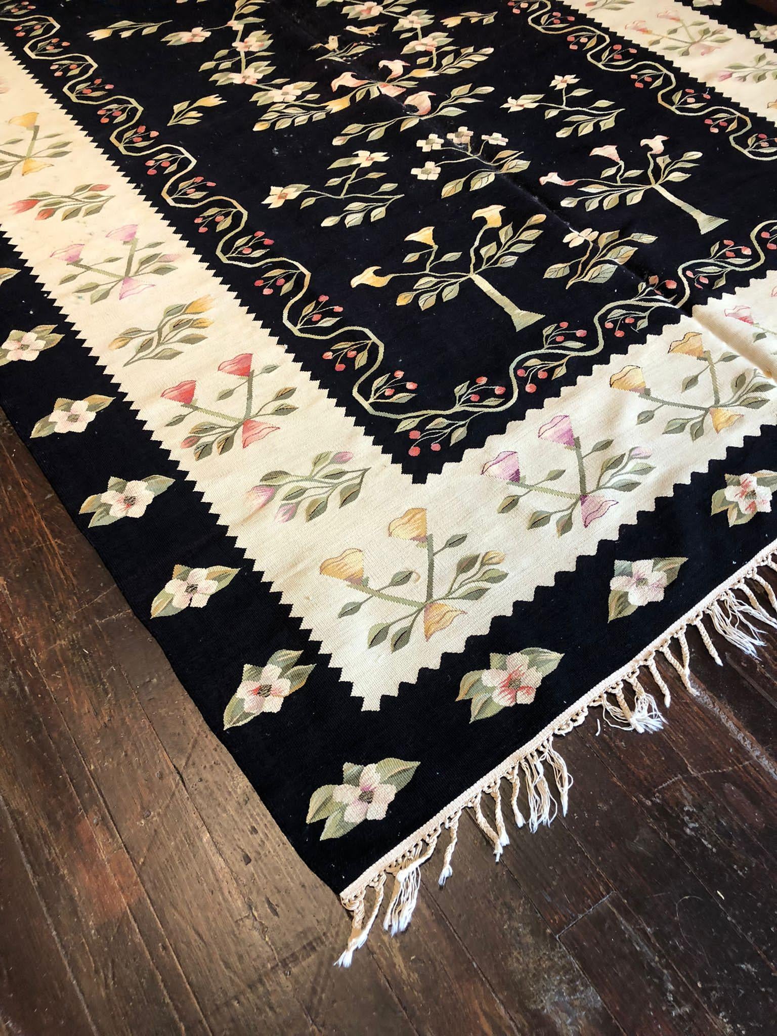  Vintage Kilim is a distinctive and charming type of flat-woven rug known for its geometric patterns and vibrant colors. This particular kilim, measuring 6 feet 8 inches by 10 feet, is a captivating piece of textile art that will add character and