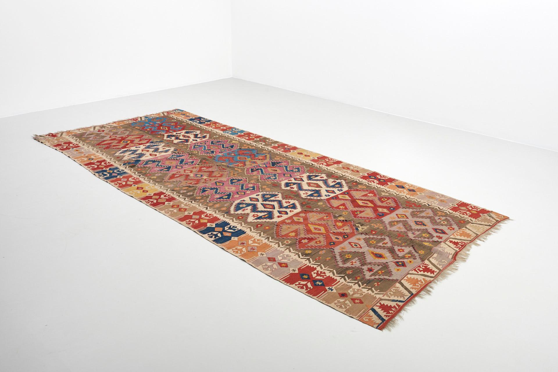 A large multicolored kilim rug in wool and cotton.