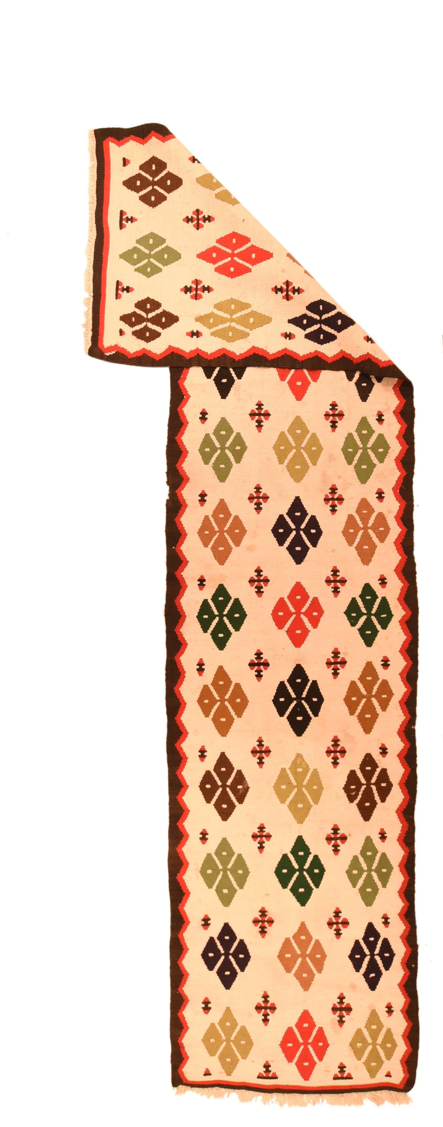 Vintage Kilim Runner 2'3'' x 9'8''. The sandy-beige field of this rustic flat woven Kenare (runner)presents three synchronized columns each of 12 four-way motives in darkest brown red and camel-straw, with smaller cruciforms in the interstices. Red