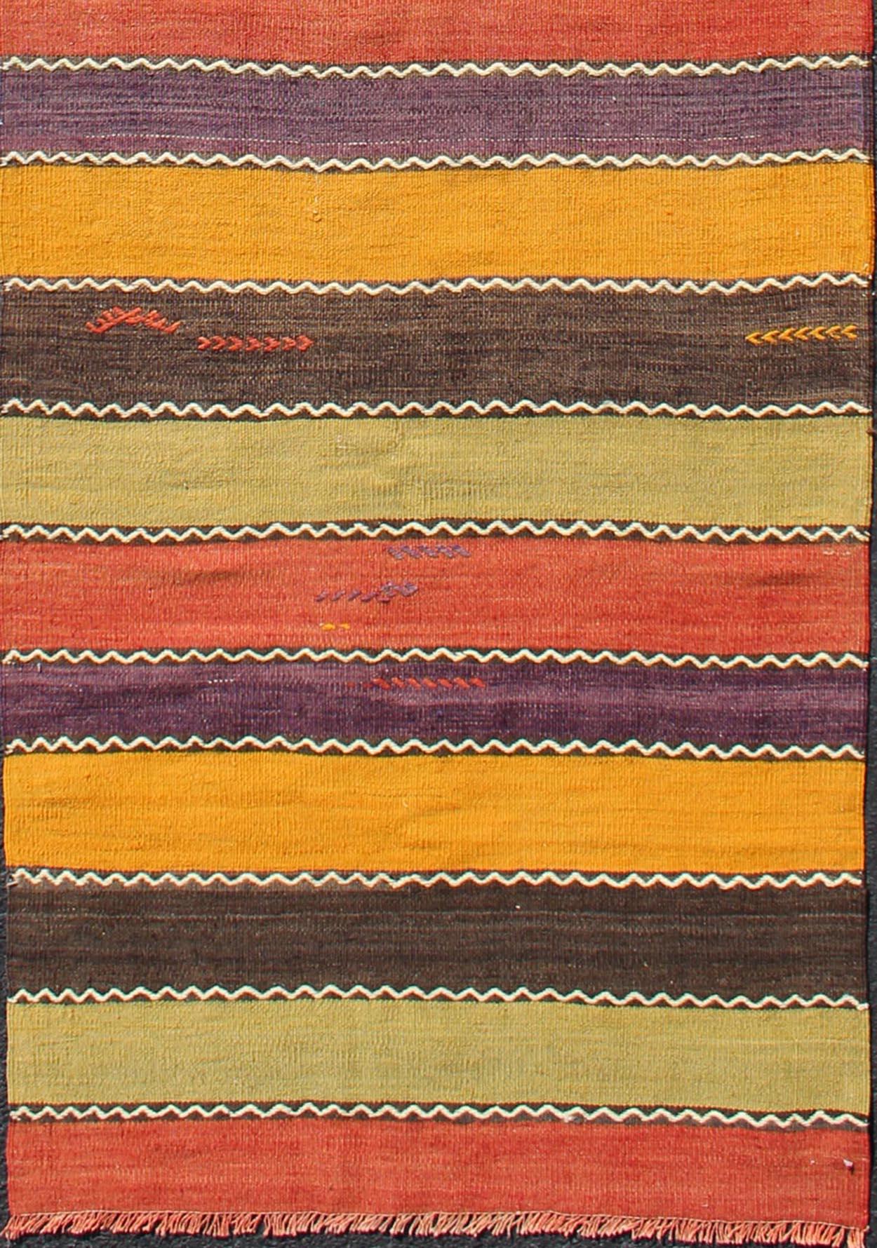 Vintage Kilim runner with horizontal stripes in orange, green, purple, red, gold, rug TU-NED-634, country of origin / type: Turkey / Kilim, circa mid-20th century

Featuring a repeating horizontal stripe design, this unique mid-century Kilim
