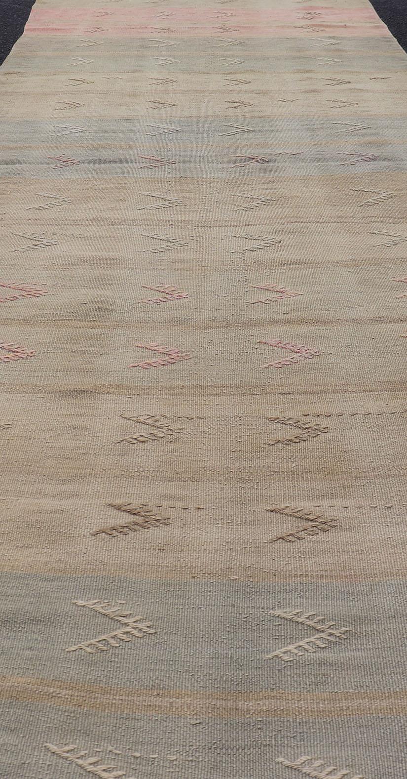 Turkish Vintage Kilim Runner with Stripes and Geometric Tribal Motifs in Light Tones For Sale