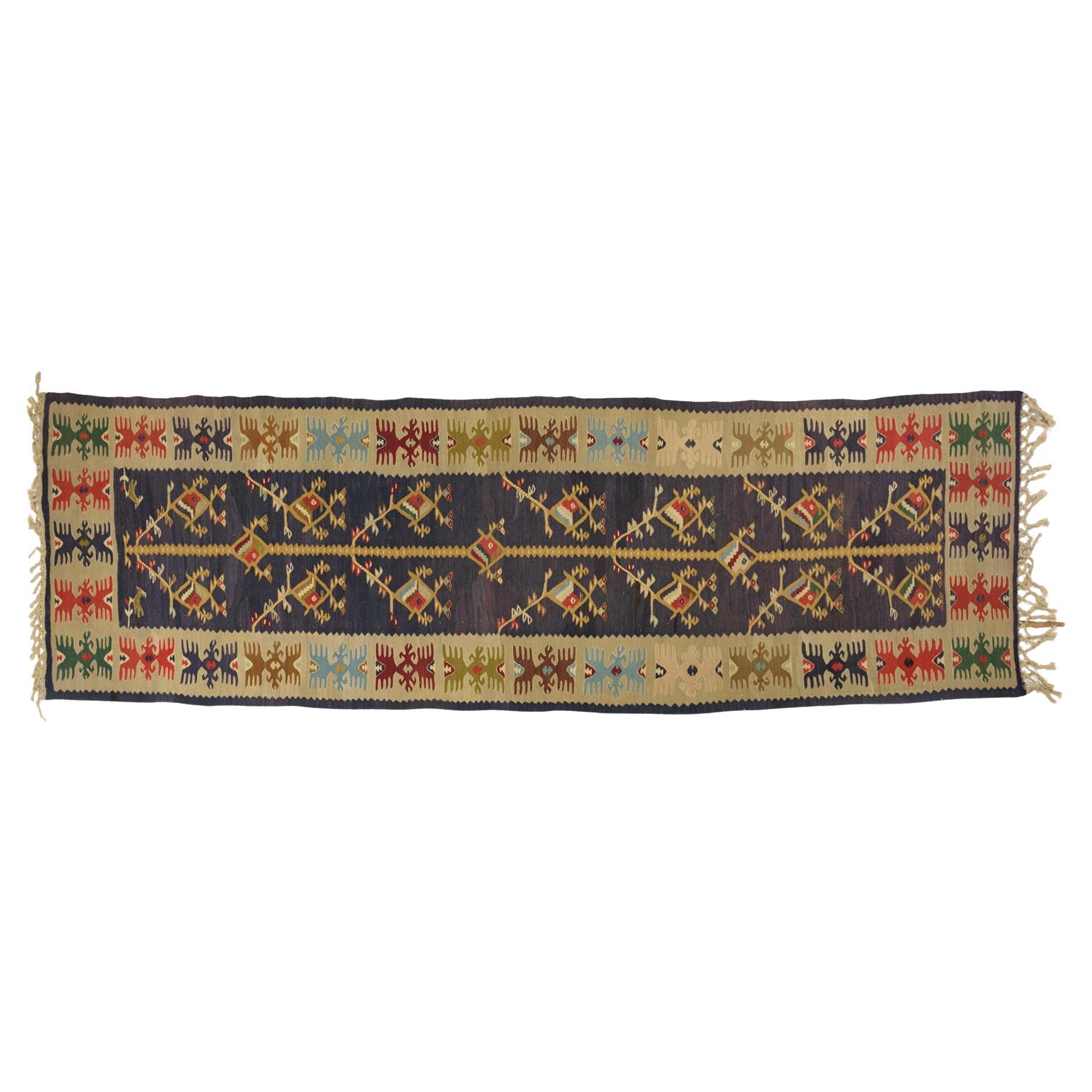 Turkish kilim runner, old but intact, with the famous indigo blue, faded by time and sun.
It looks beautiful in front of a bookcase or elsewere.
If necessary, I recommend a light underlay, commonly used for kilims.

ref. nr. 447.
