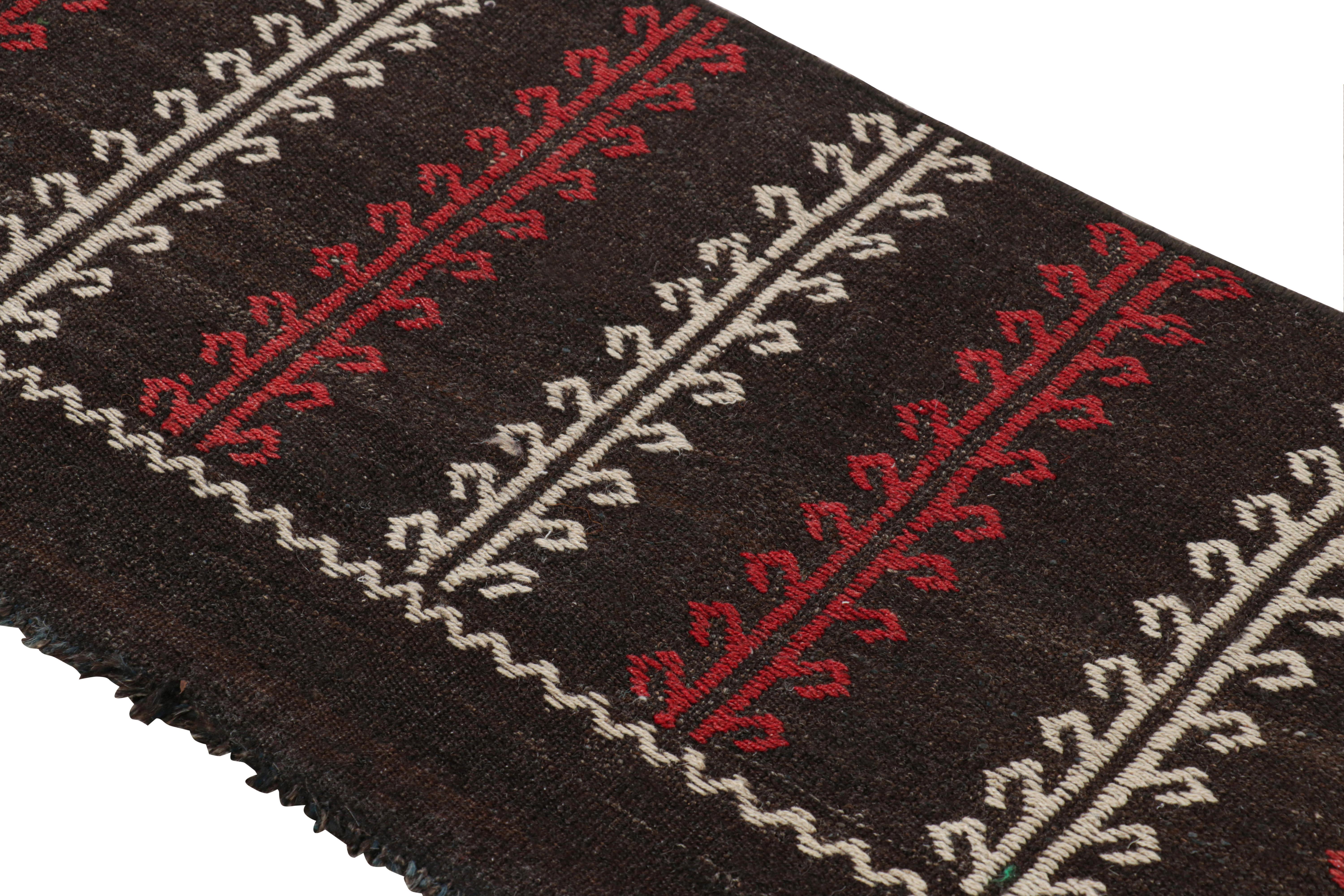 Handwoven in wool and originating from Turkey circa 1950-1960, this 2x6 kilim’s design features a textural element in the geometric patterns—a double-weft style of embroidery as one will see in the raised stripes with latch hooks 

On the Design: