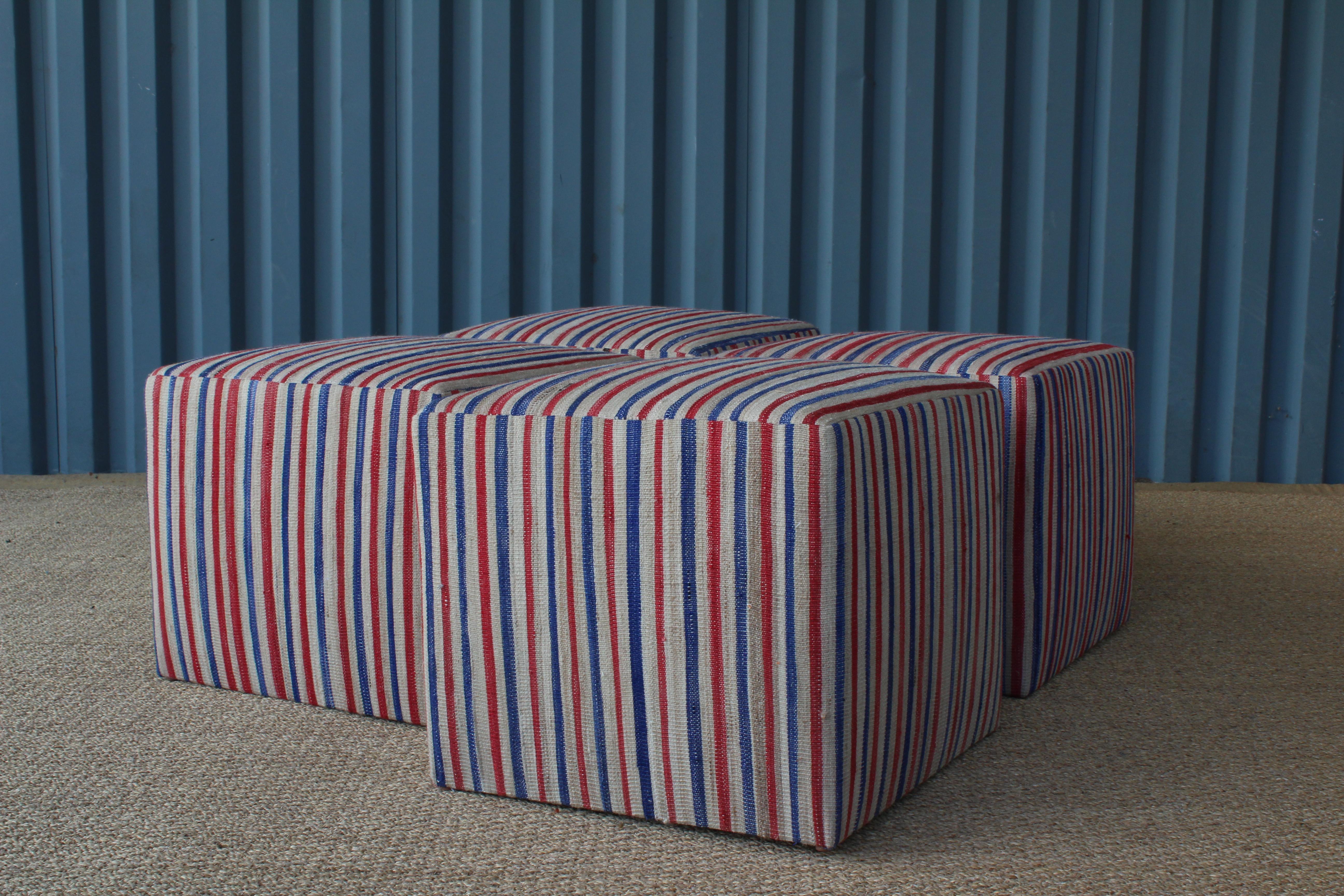 Custom made upholstered stools in a vintage striped kilim in red, white and blue. Three available.