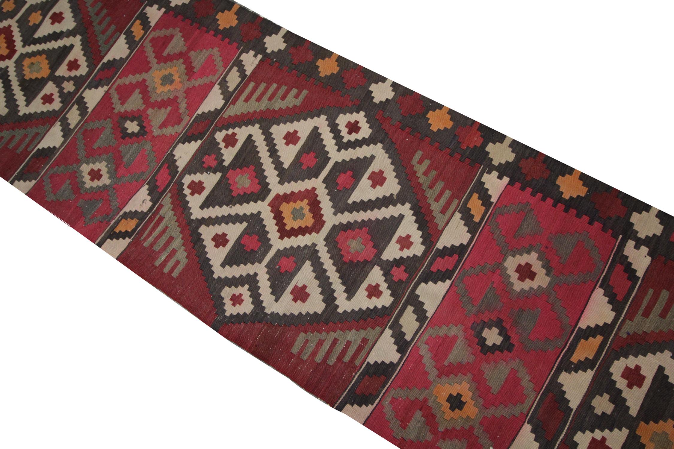 This fine wool Kilim Runner is a modern flat-weave Kilim rug constructed in the early 2000s. The design features a repeat geometric design woven with a vibrant colour palette including green, rust, beige and brown that make up the repeat geometric