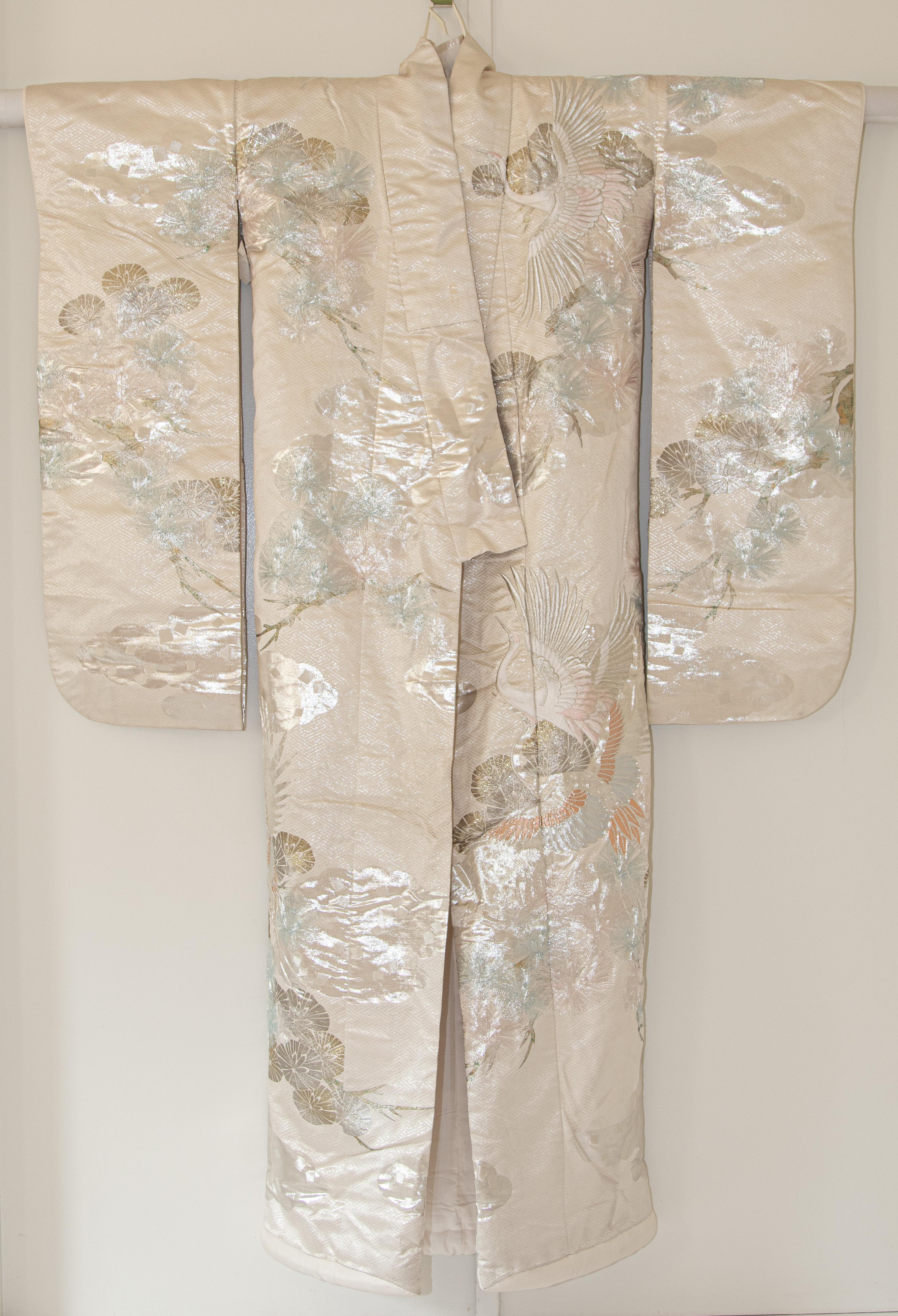 A vintage mid-century silk brocade collectable Japanese ceremonial wedding kimono.
One of a kind handcrafted fabulous museum quality ceremonial piece in white silk with intricate detailed hand-embroidery throughout accented with peacock lame threads