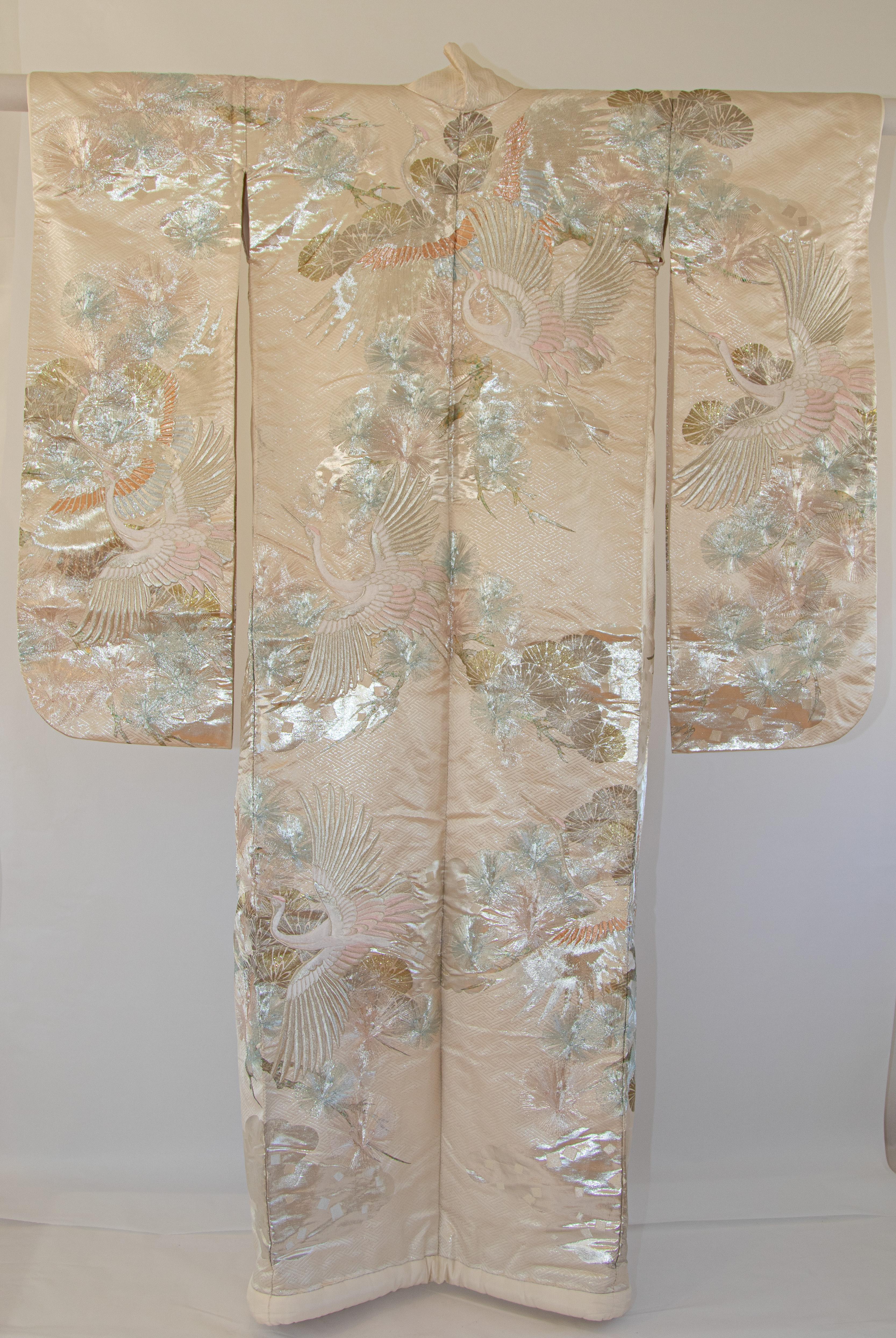 A vintage mid-century silk brocade collectable Japanese ceremonial wedding kimono.
One of a kind handcrafted fabulous museum quality ceremonial piece in white silk with intricate detailed hand-embroidery throughout accented with peacock lame threads