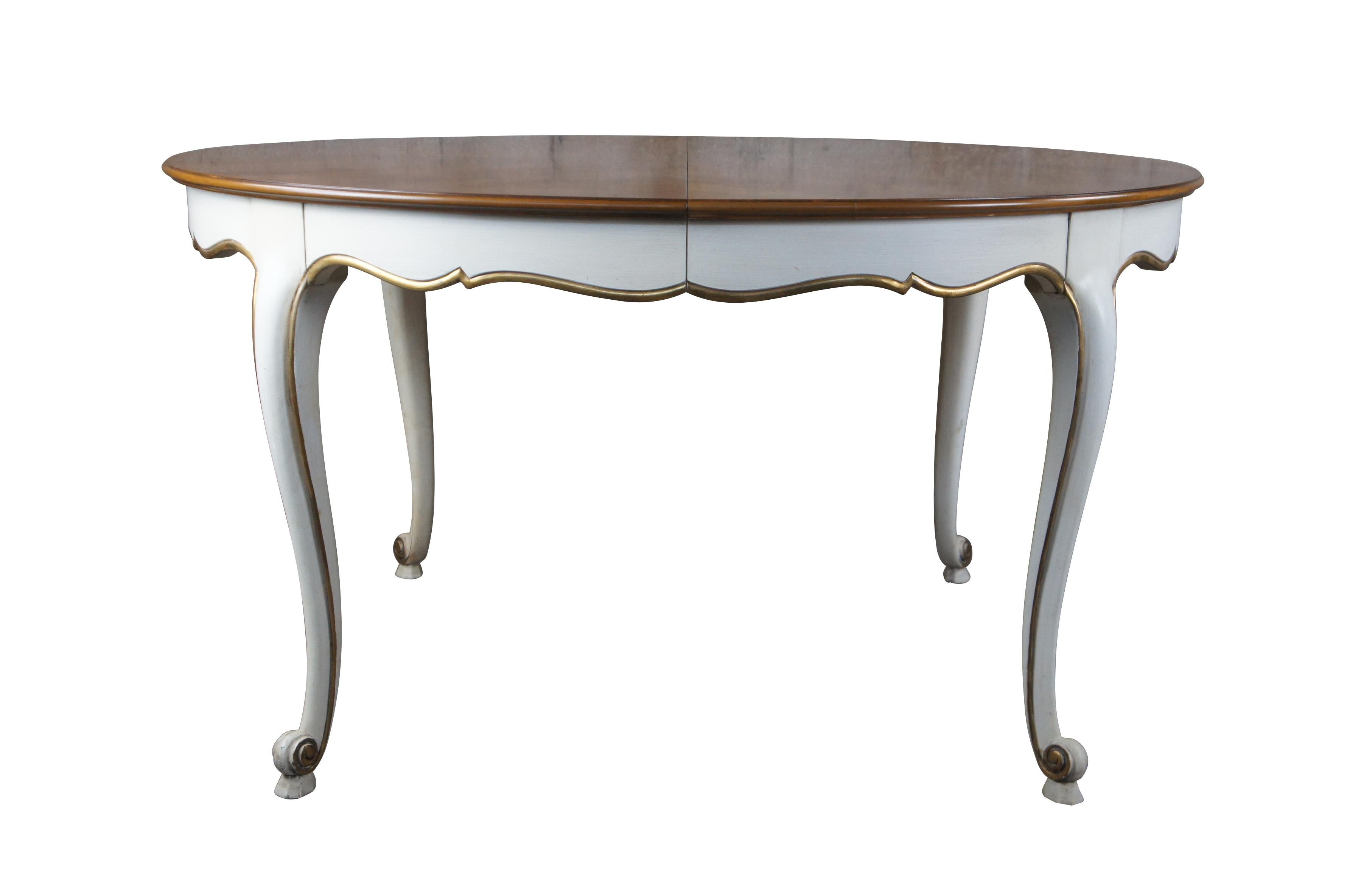 Vintage Kindel Furniture Belvedere Collection extendable dining table.  Made of Cherry featuring oval form with scalloped skirt and cabriole legs painted white with gold accents.  Includes three leaves.

Kindel Grand Rapids has maintained family