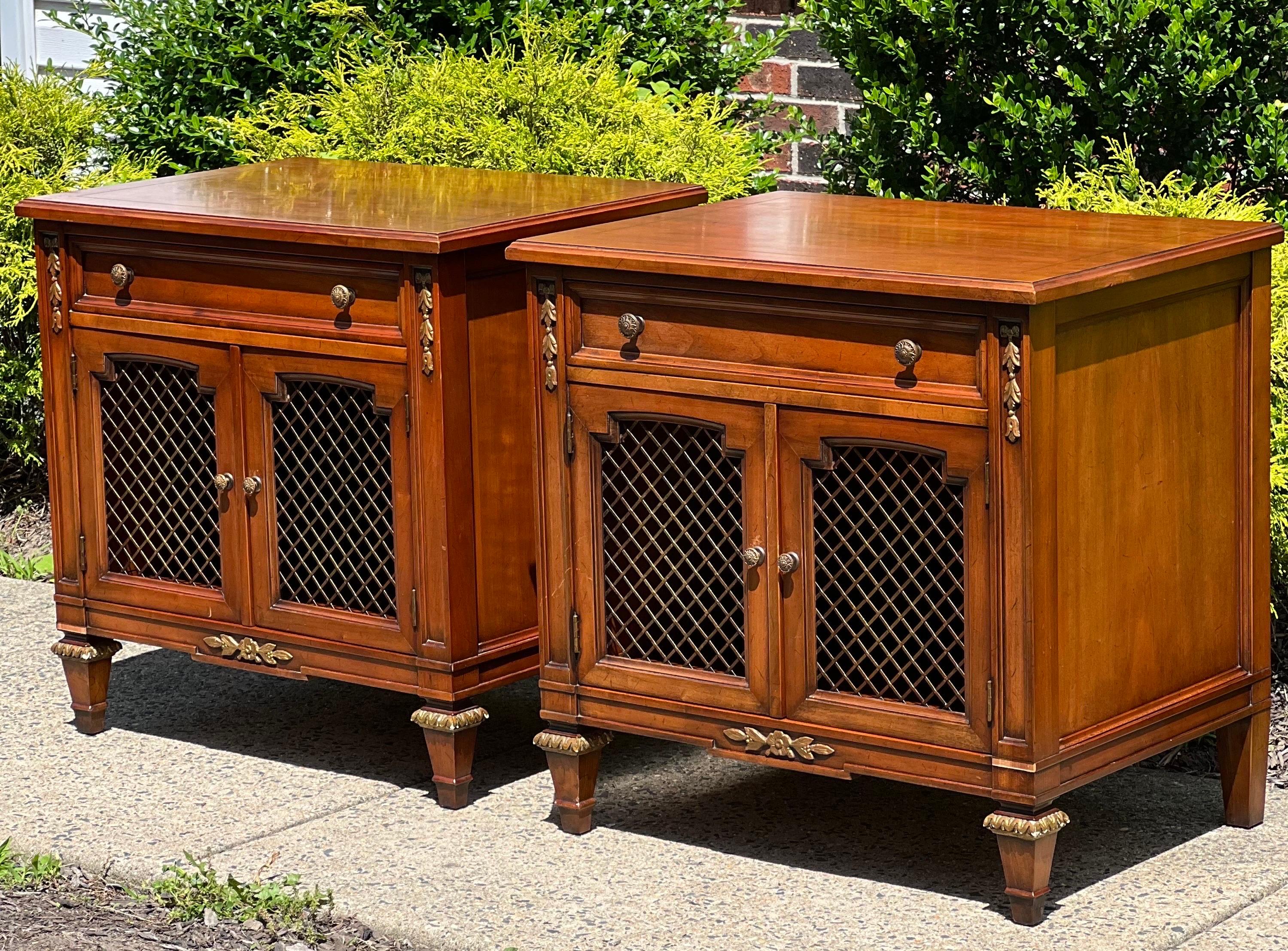 Stately French Regency style nightstands American crafted by Kindel Furniture of Grand Rapids, Michigan, 1980's.

Part of the Belvedere Collection, these nightstands are made from rich cherry wood and feature original brass hardware and ormolu.