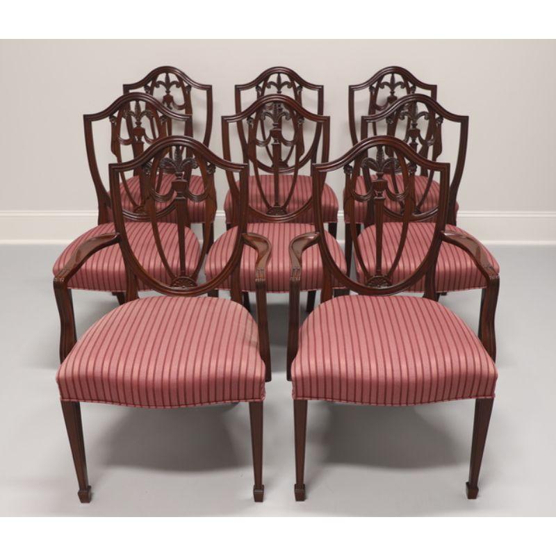 A set of six dining chairs in the Georgian Hepplewhite style by Kindel Furniture. Inlaid mahogany with carved seatbacks with plumes, upholstered seats, and tapered legs with spade feet. Four side chairs and two armchairs. Made in Grand Rapids,