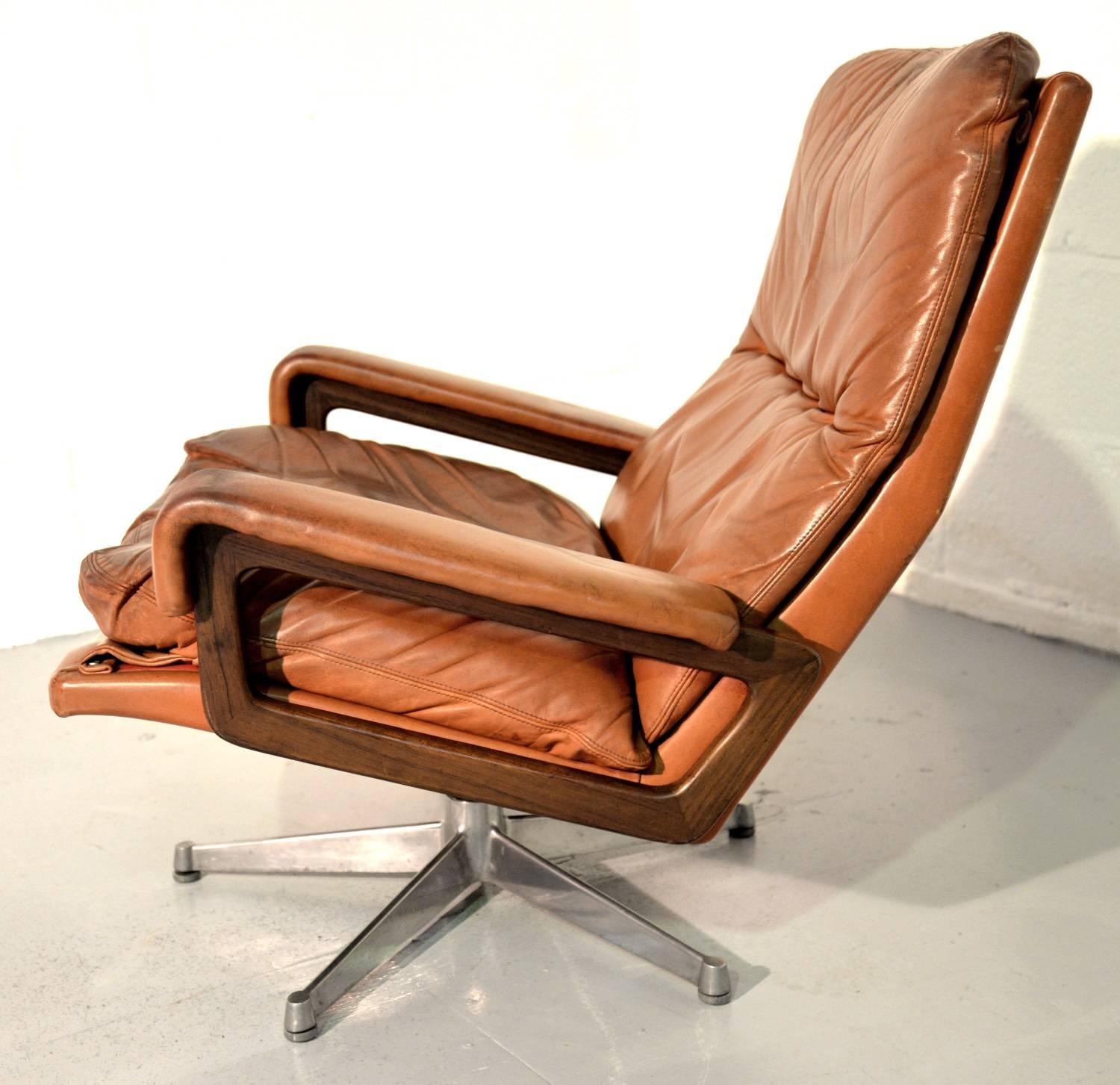 Discounted airfreight for our US and International customers ( from 2 weeks door to door)

A vintage lounge King armchair by Strassle of Switzerland. Designed by Andre Vandenbeuck of Belgium, the swivel lounge armchair is upholstered in stunning tan