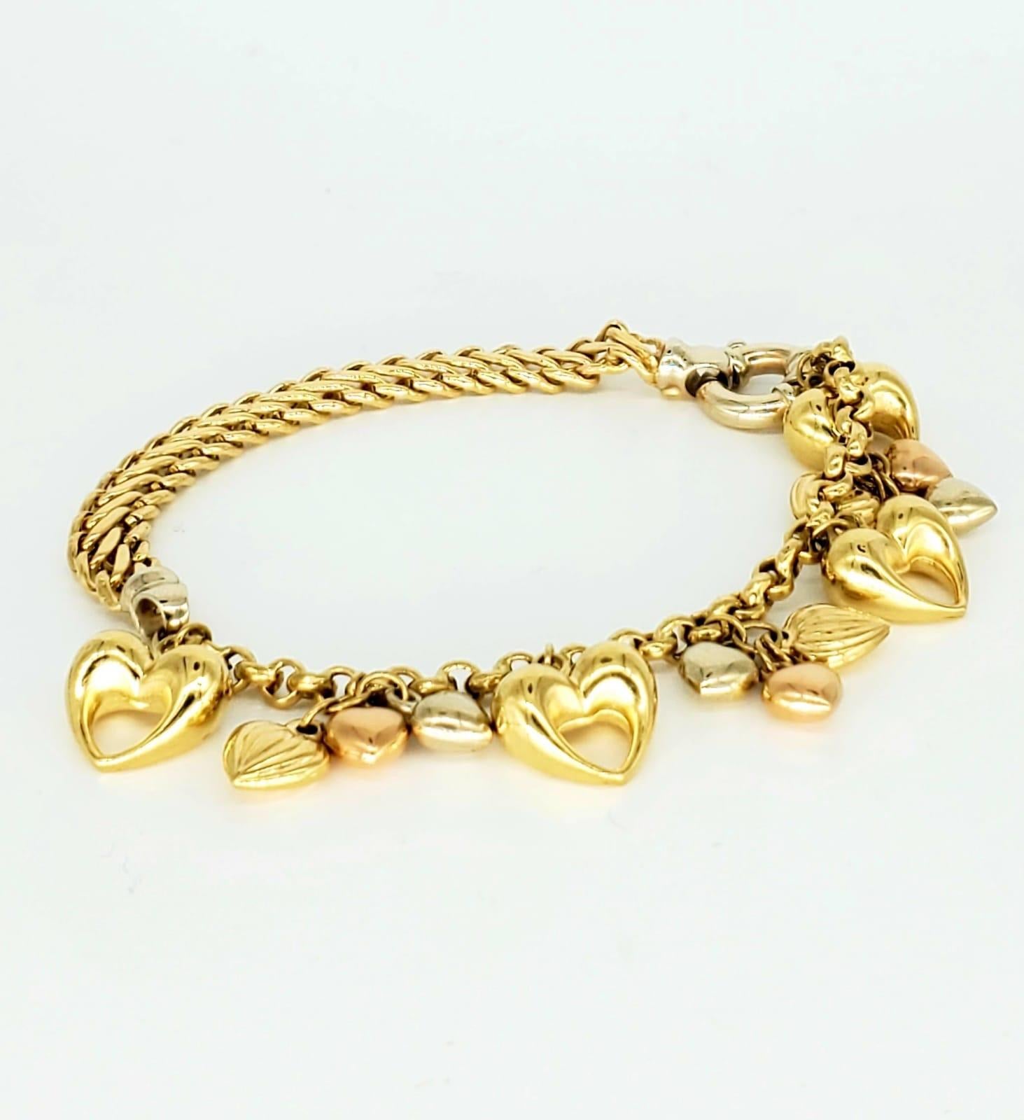 Vintage Kingdom of Hearts 18k Gold Bracelet. The bracelet is beautiful and noticeable in public. The bracelet is 7.5 inches in length and is 6.5mm wide. The bracelet is made of 18k gold and features yellow gold, white gold and rose gold hearts. The