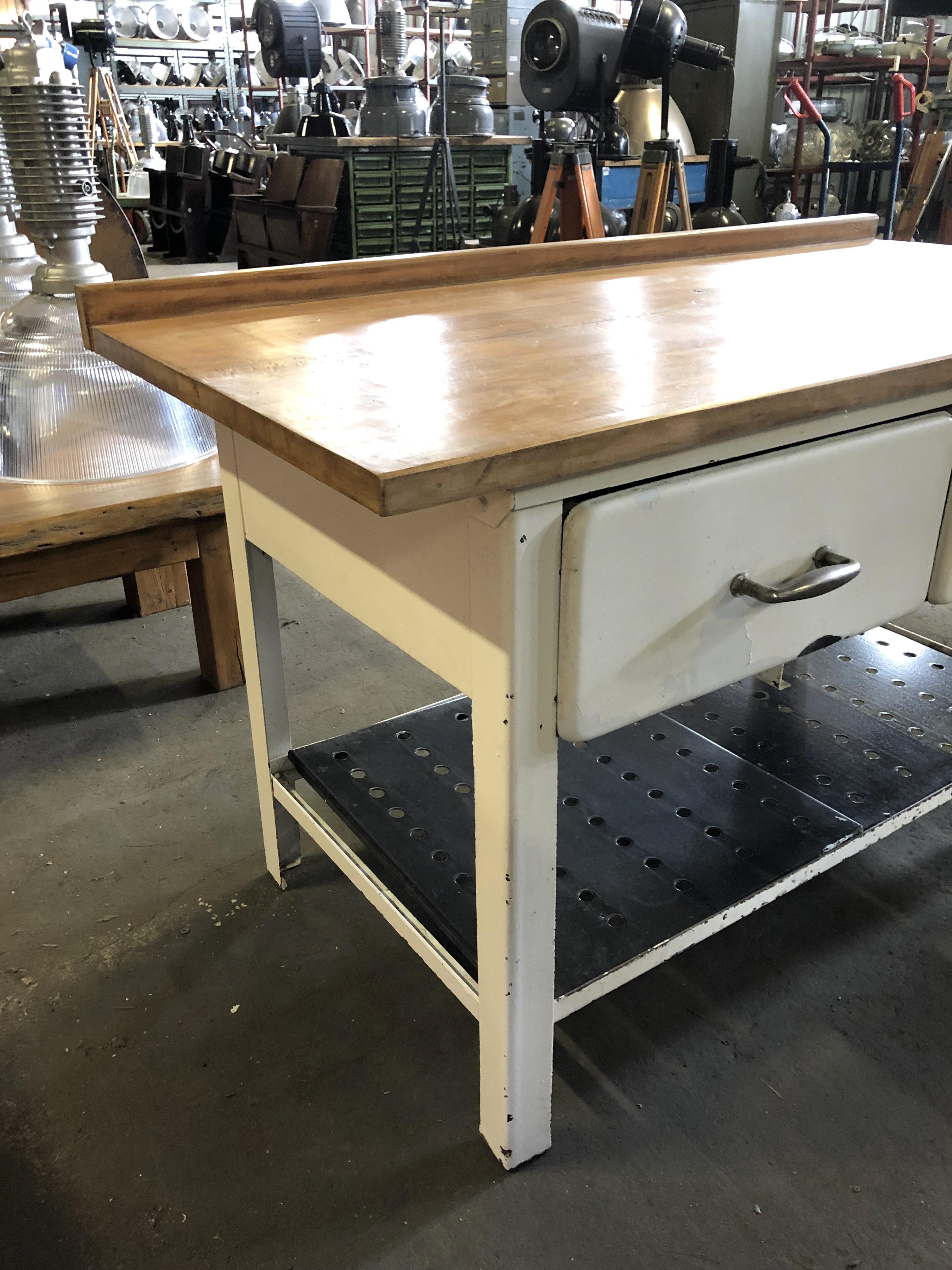Vintage kitchen worktable. It features iron construction with two drawers and original wooden plate.
Drawer dimensions: 62 x 49 x 18 cm.