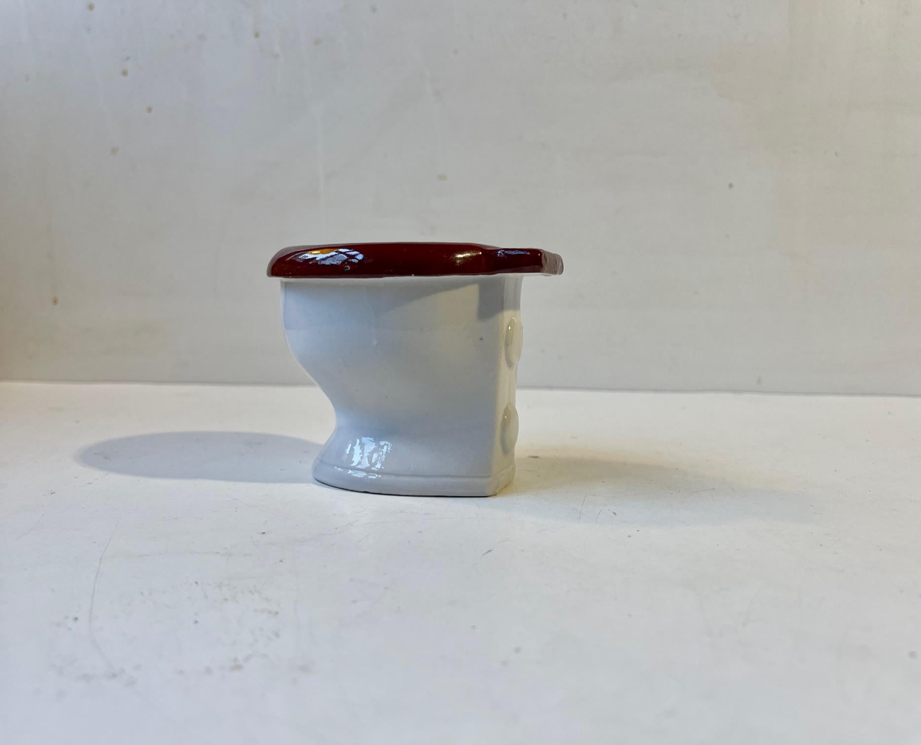 Do an ashtray become political correct when it is shaped as a toilet. Nevertheless this 'piece' was made in West Germany circa 1960-70. It is signed, numbered and measures 8 cm in height with a dept of 10 cm and a width of 8 cm. We recon it has seen