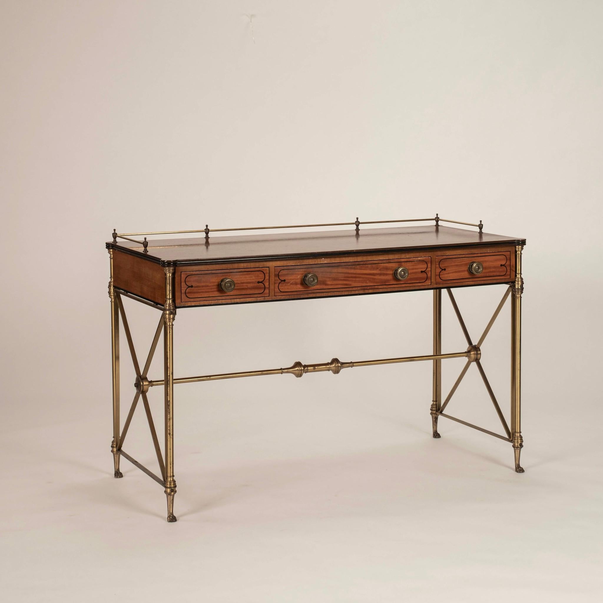 1960s Vintage Kittinger Directoire style writing desk composed of satinwood and features ebony inlay and brass hardware. Maker's mark located inside the center drawer.