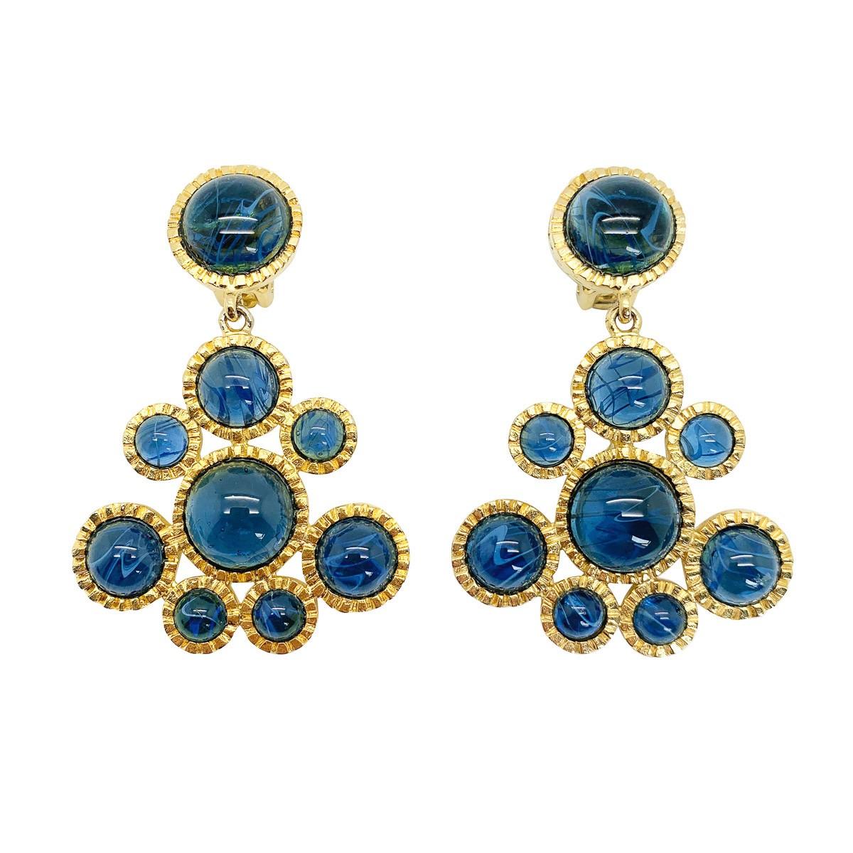 An outstanding pair of vintage KJL Sapphire earrings oozing glamour and style. Featuring a wonderfully designed crimped gold mount of statement proportion. Set to perfection with exquisite stones - large cabochon sapphire blue with a 'flawed'