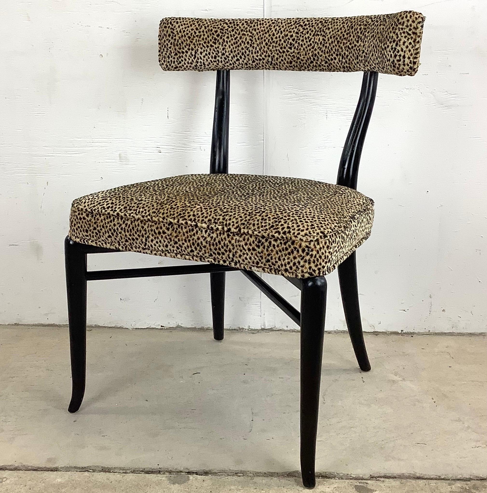 This impressive midcentury Klismos chair features the distinctive sculptural style of reknown designer T.H. Robsjohn Gibbings- this vintage chair has a black lacquer finish and unique leopard print upholstery and makes a striking side chair in any