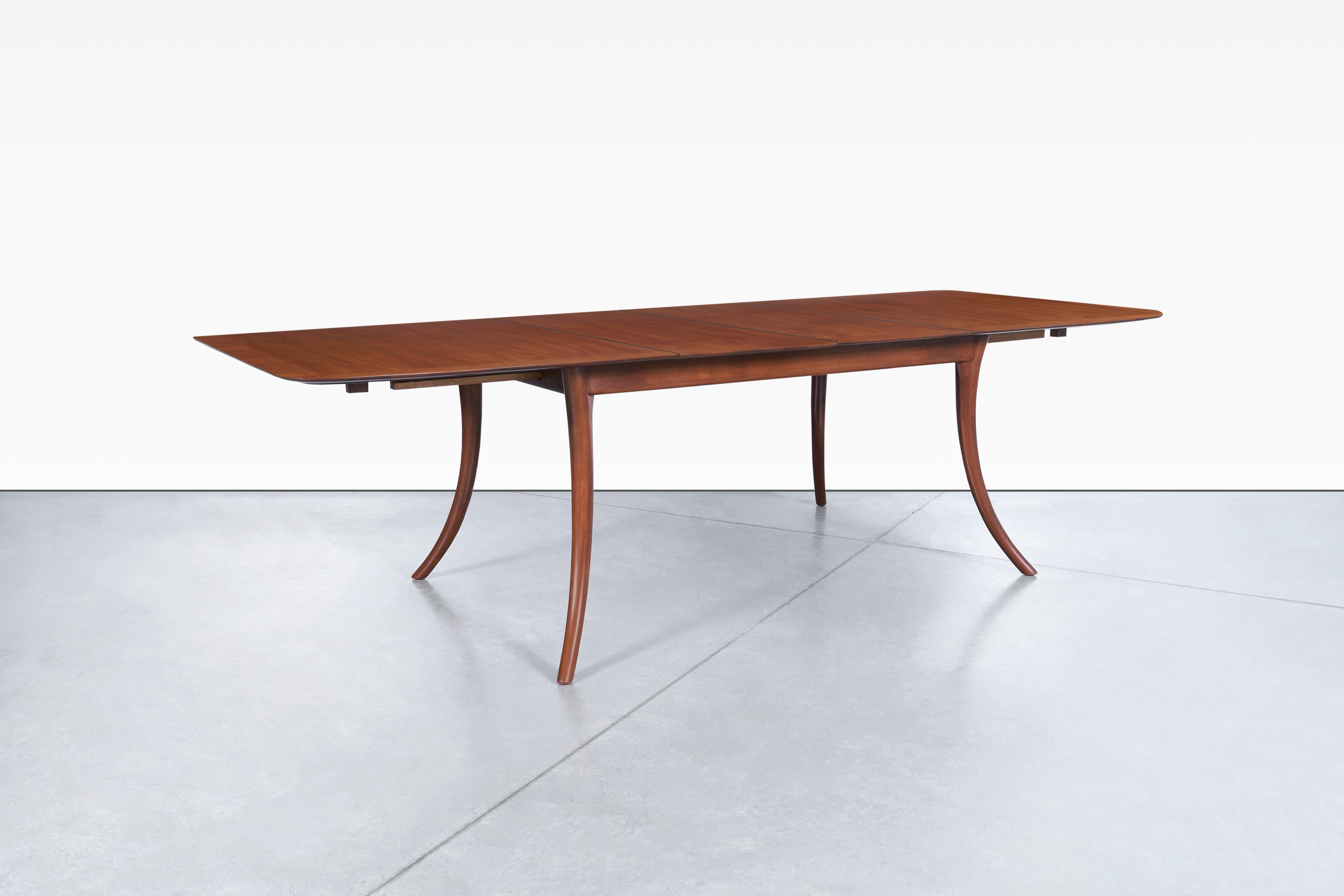 Stunning vintage dining table designed by T.H. Robsjohn-Gibbings for Widdicomb in the United States, circa 1950s. Indulge in the ultimate dining experience with our rare and unique mahogany dining table, also known as model 4301. This stunning piece