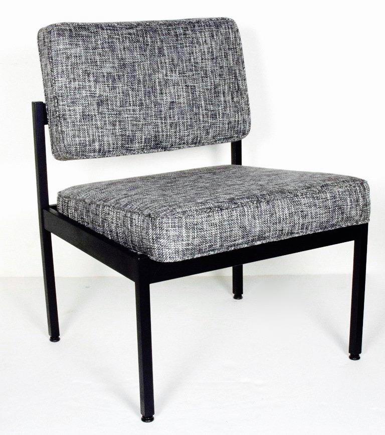 Mid-Century Modern chair with minimalist industrial design. Fine example of utilitarian furniture, great as an office chair or as an easy chair. Satin black enameled metal frame is complimented by a black and ivory woven tweed upholstery by Rogers &