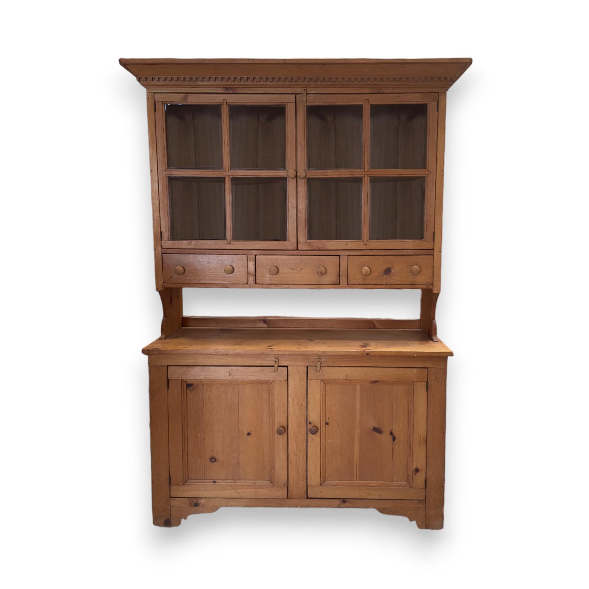 Vintage Knotted Pine Kitchen Cupboard with windowed upper cabinets, pull out drawers, and bottom shelving.