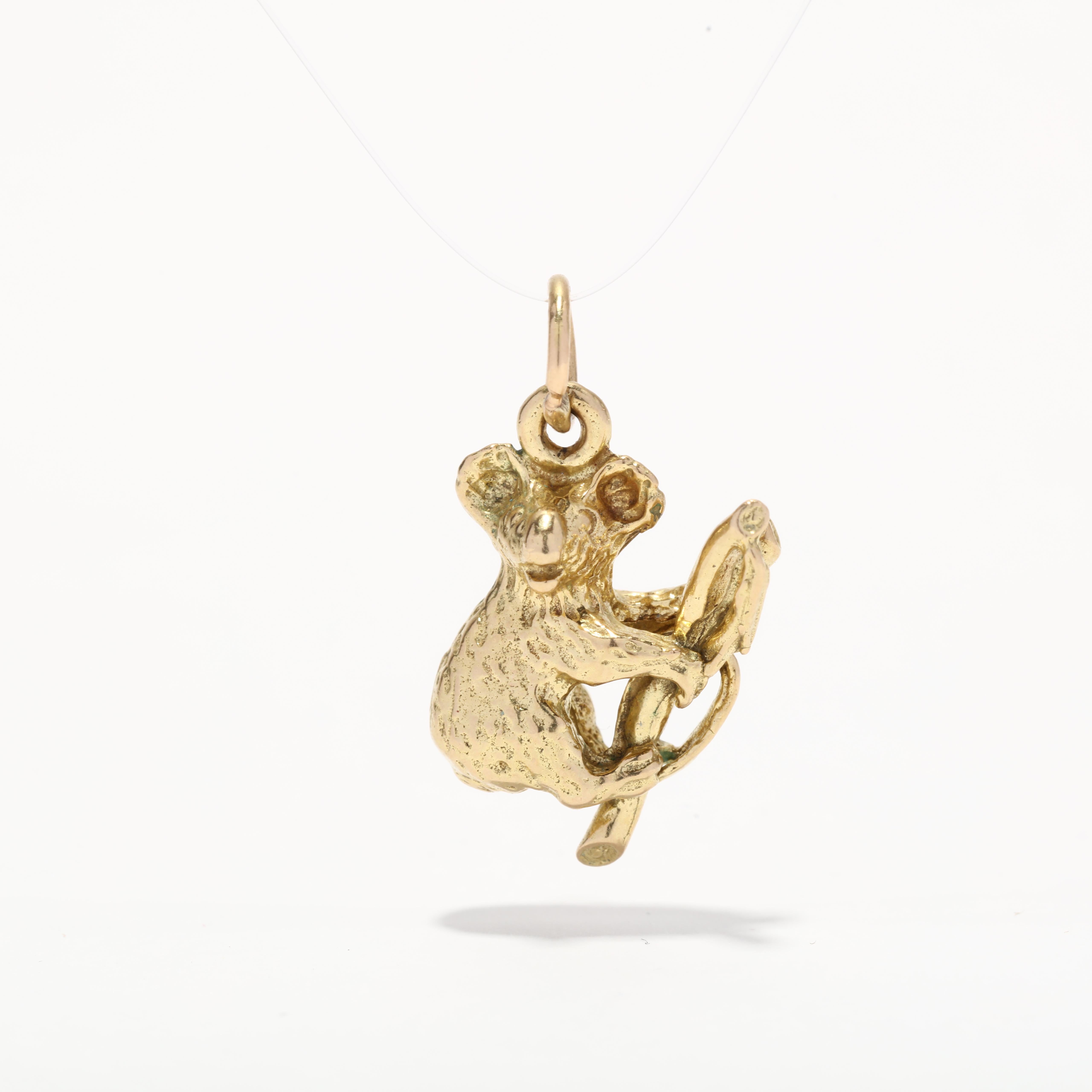 A vintage 18 karat yellow gold koala charm. This small charm features a koala bear climbing a branch with a textured finish and a thin bail.

Length: 7/8 in.

Width: 1/2 in.

Weight: 3.8 dwts.

Ring Sizings & Modifications:
*Please reach out before