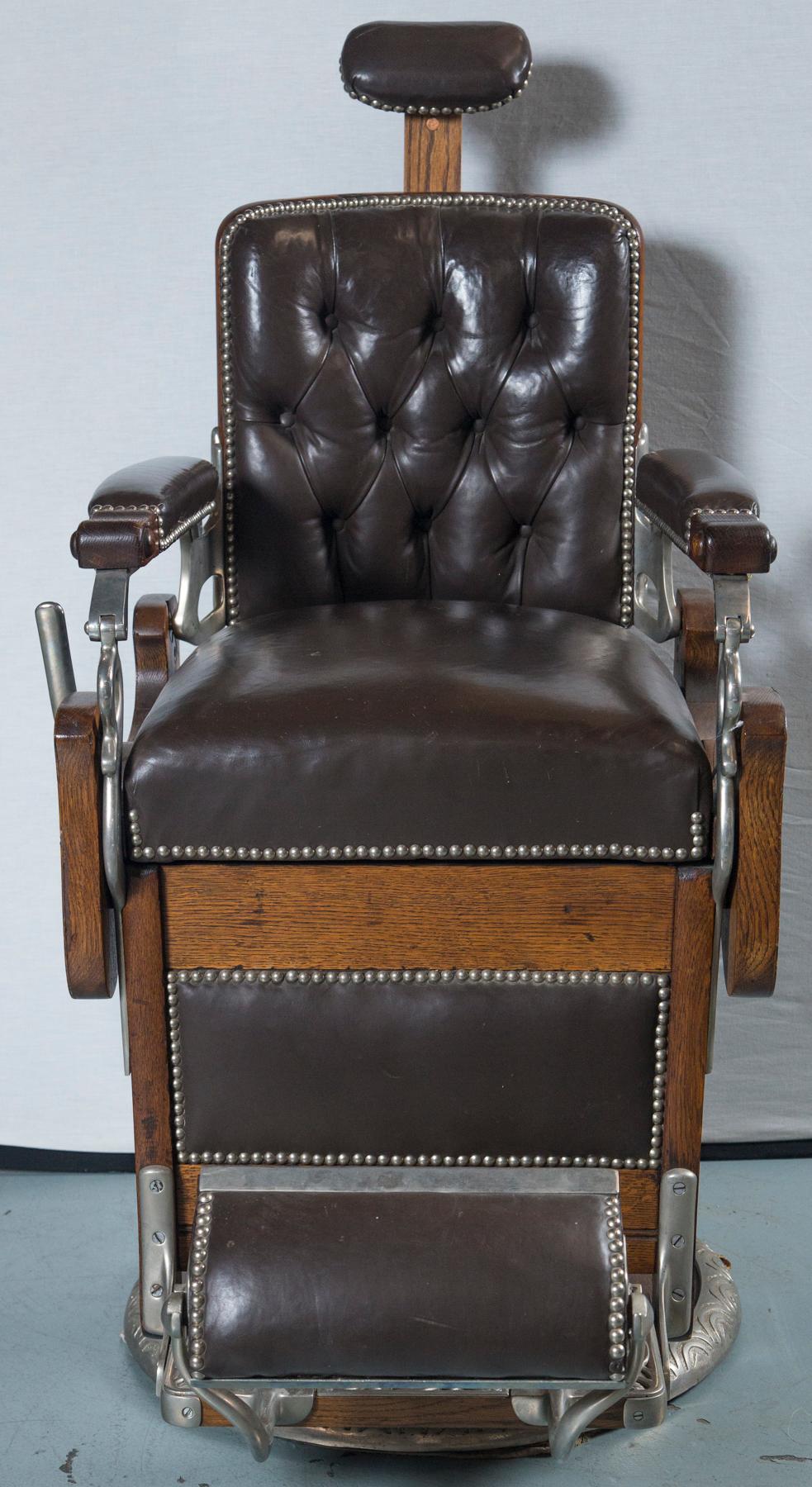 Beautiful vintage barber's chair. Signed Koken Barbers' Supply Co. St. Louis, USA Original tag on back side of chair and on the footrest. Made circa 1890 of oak with carved details on each side. Leather and nailheads replaced but in very good